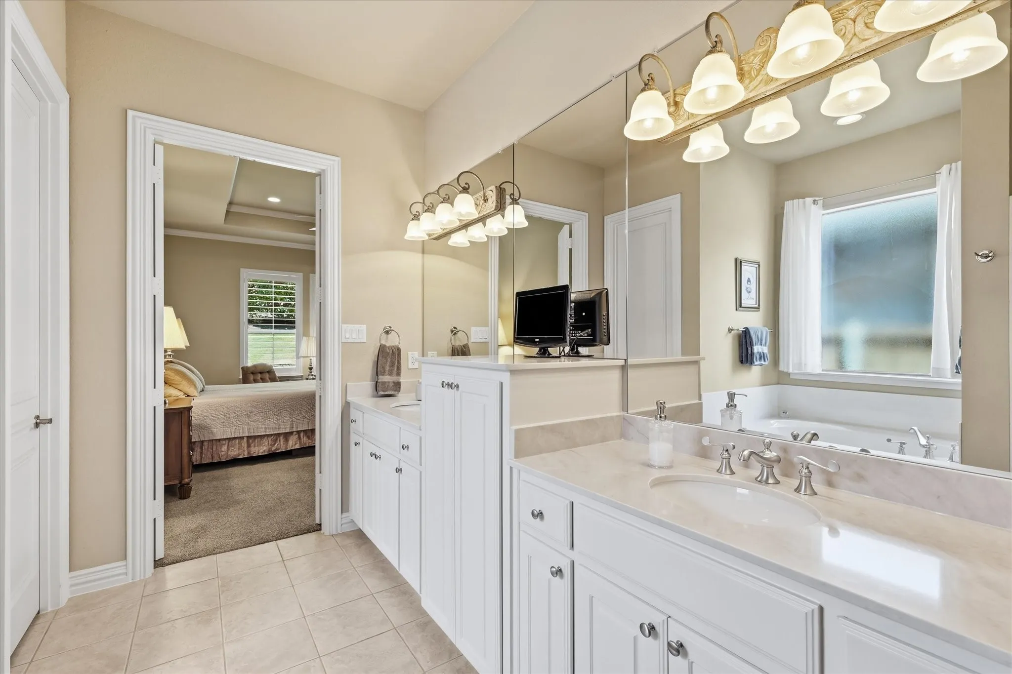 Dual vanity with white cabinetry, light-toned countertop, and undermount sinks