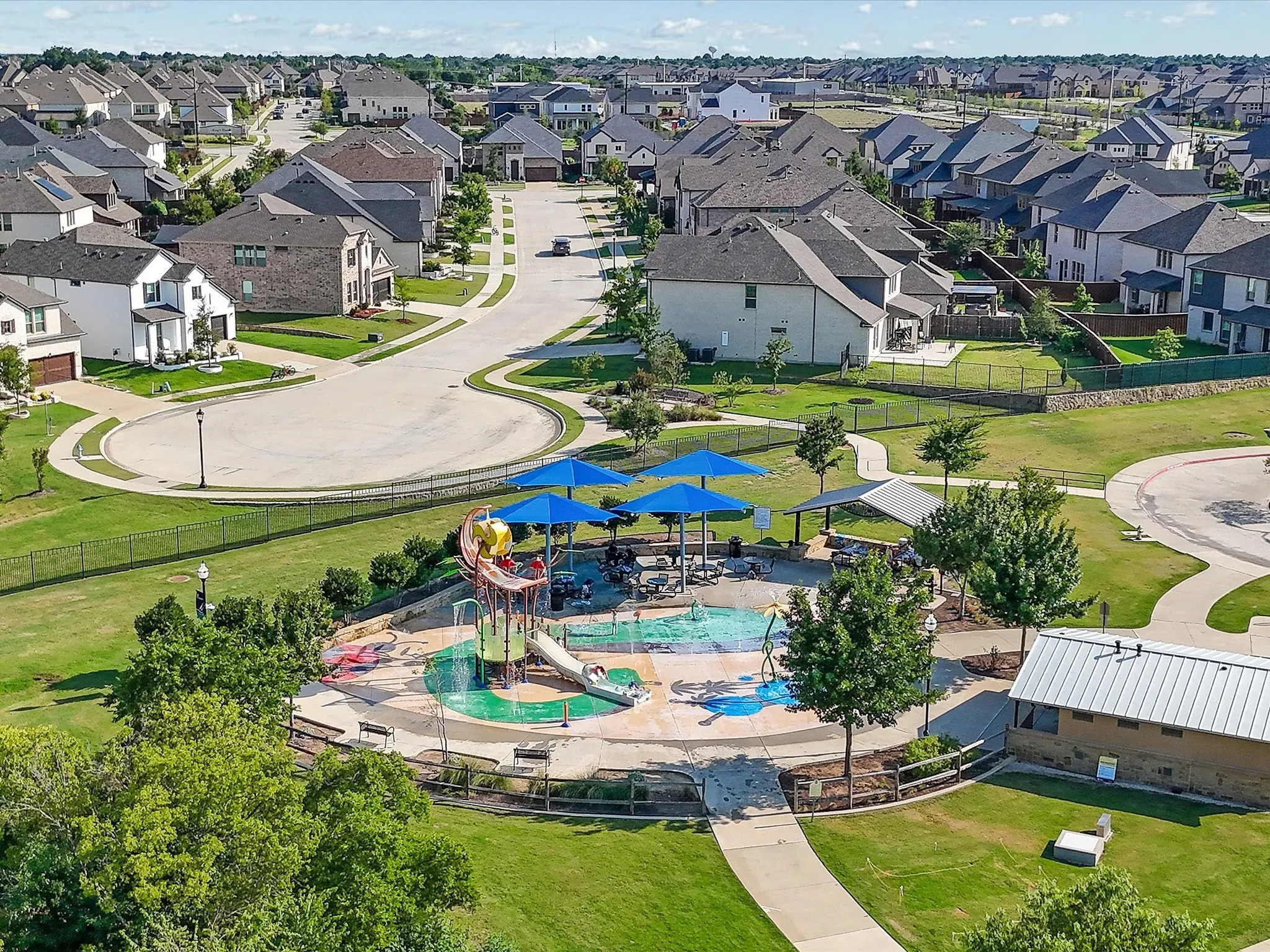 Aerial perspective of McCord Park featuring a pavilion, pool, and splash park.