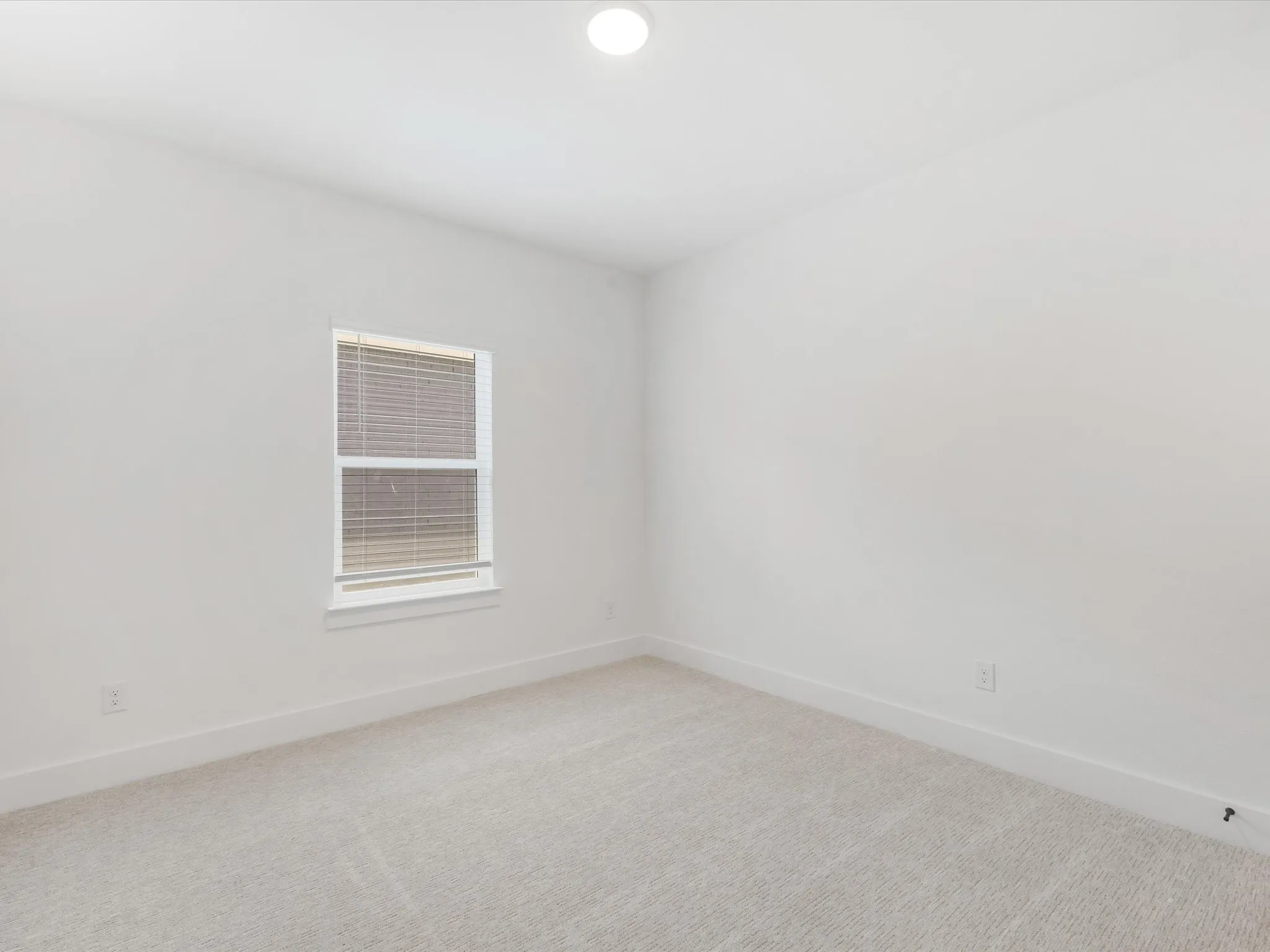 Bedroom 4 with baseboards and light carpet