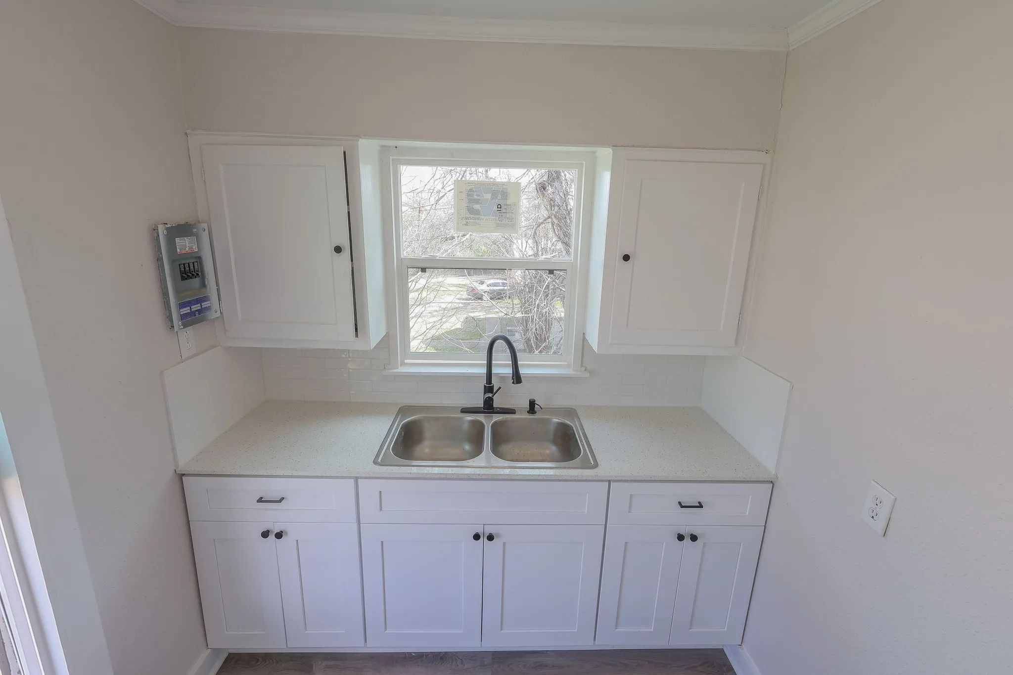 White shaker-style cabinetry with matte black hardware