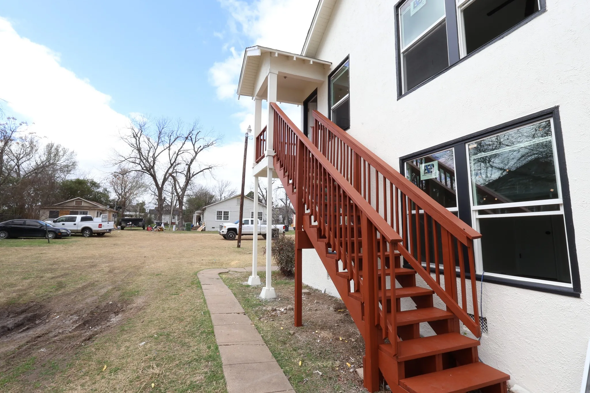 Exterior staircase with wood-finish railings and treads