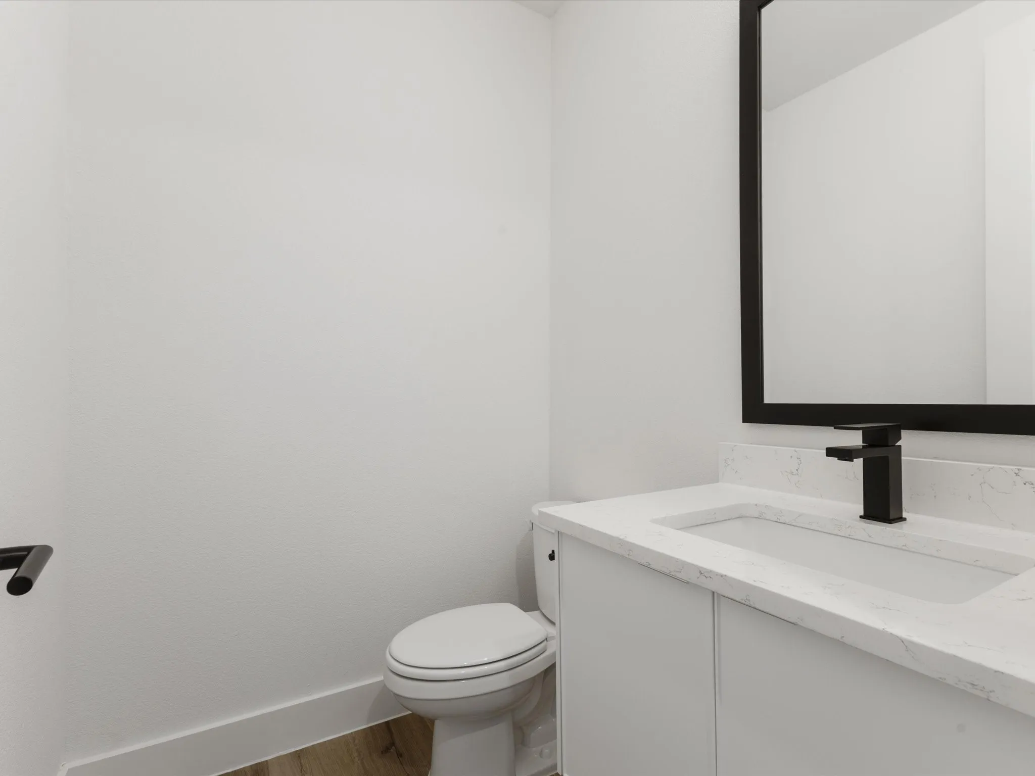 Powder Bathroom featuring vanity and wood finished floors