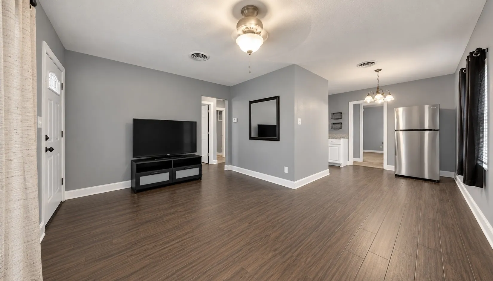 Wood-finish flooring throughout, light gray wall paint, and white trim