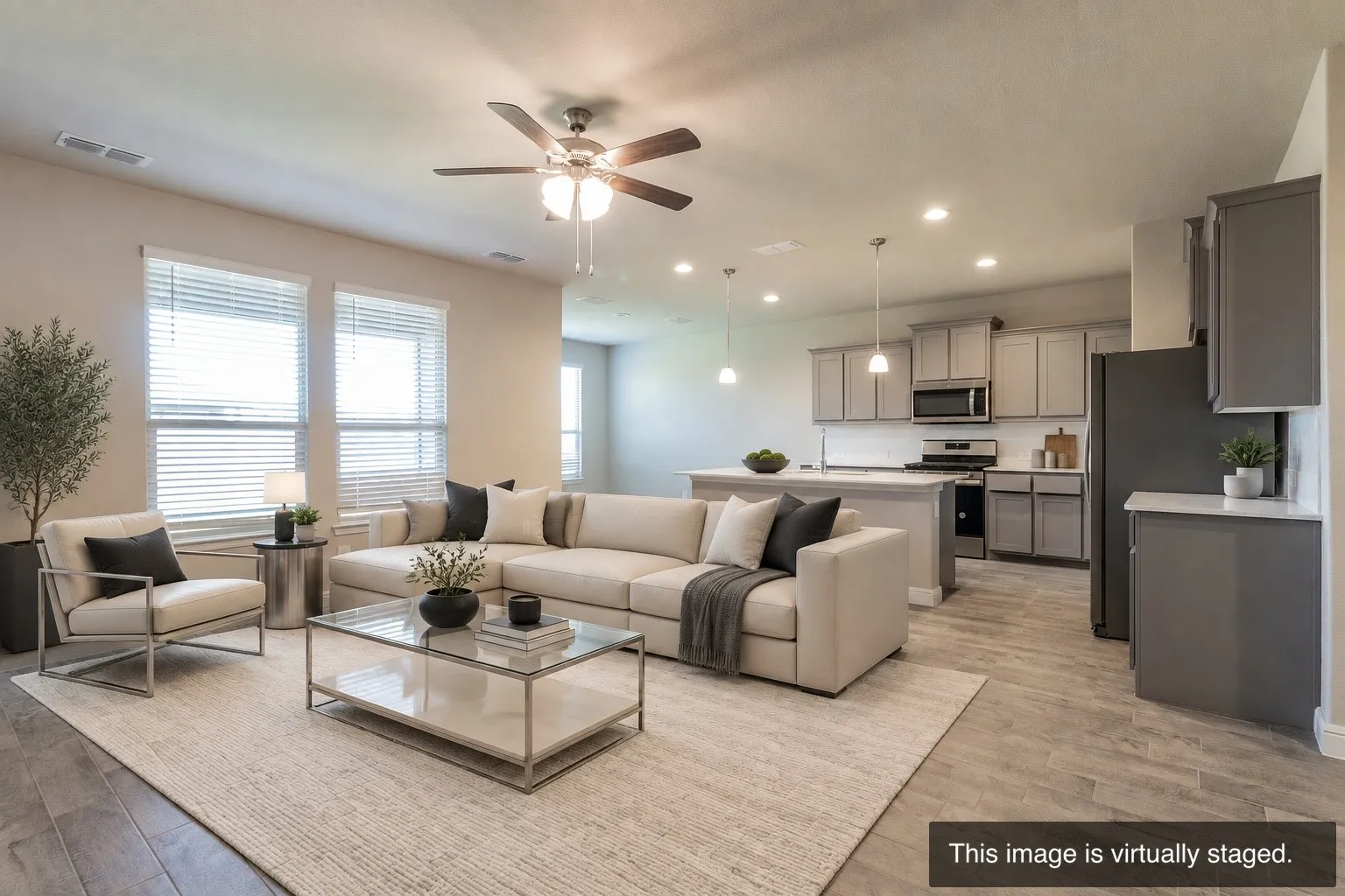 Open-concept living space featuring wood-finish flooring, recessed lighting, and a ceiling fan