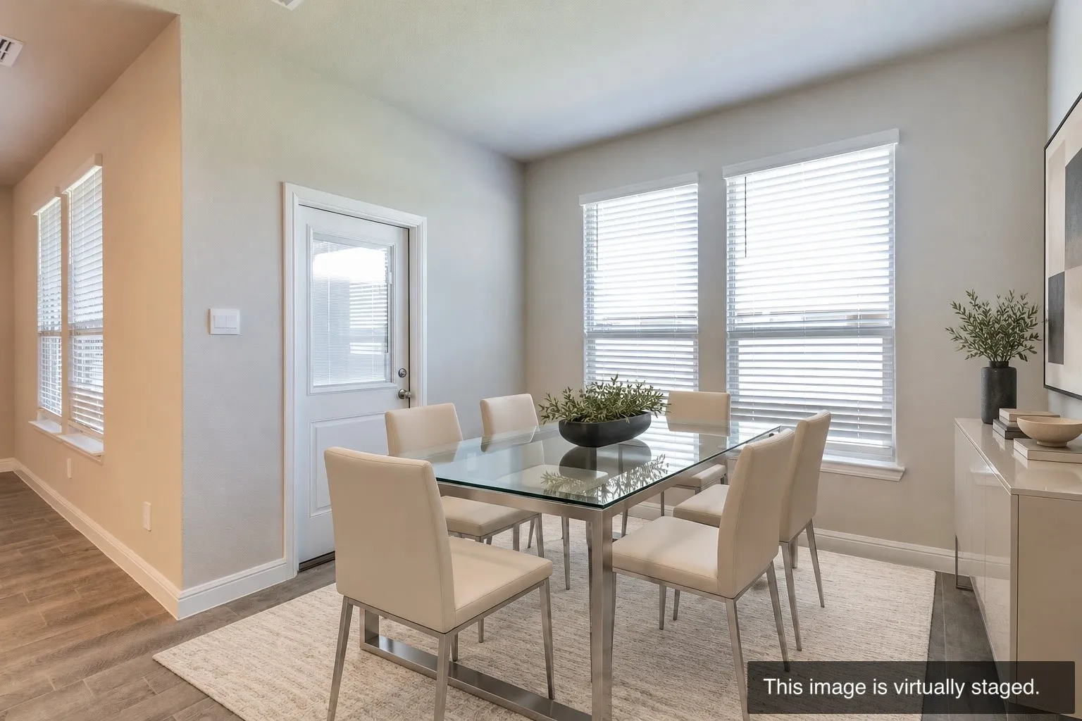 Recessed lighting, wood-finish flooring, multiple windows with blinds, a white door with a glass insert, and light-toned walls