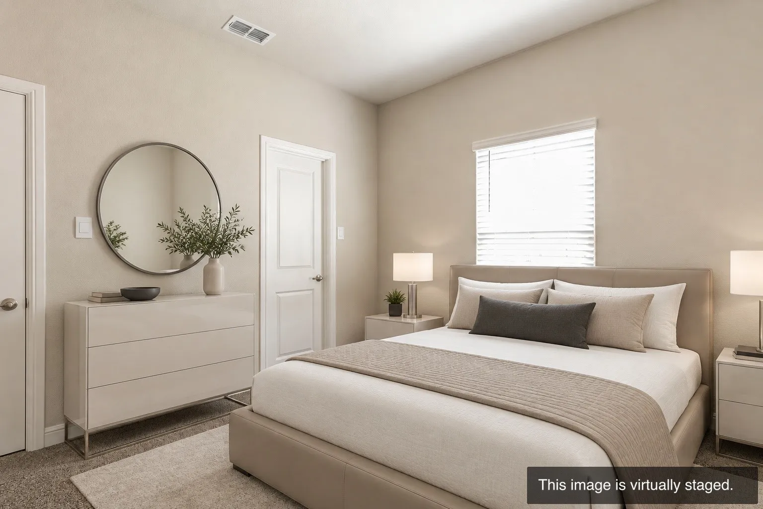 Recessed lighting, light-toned walls, and neutral-toned carpeting