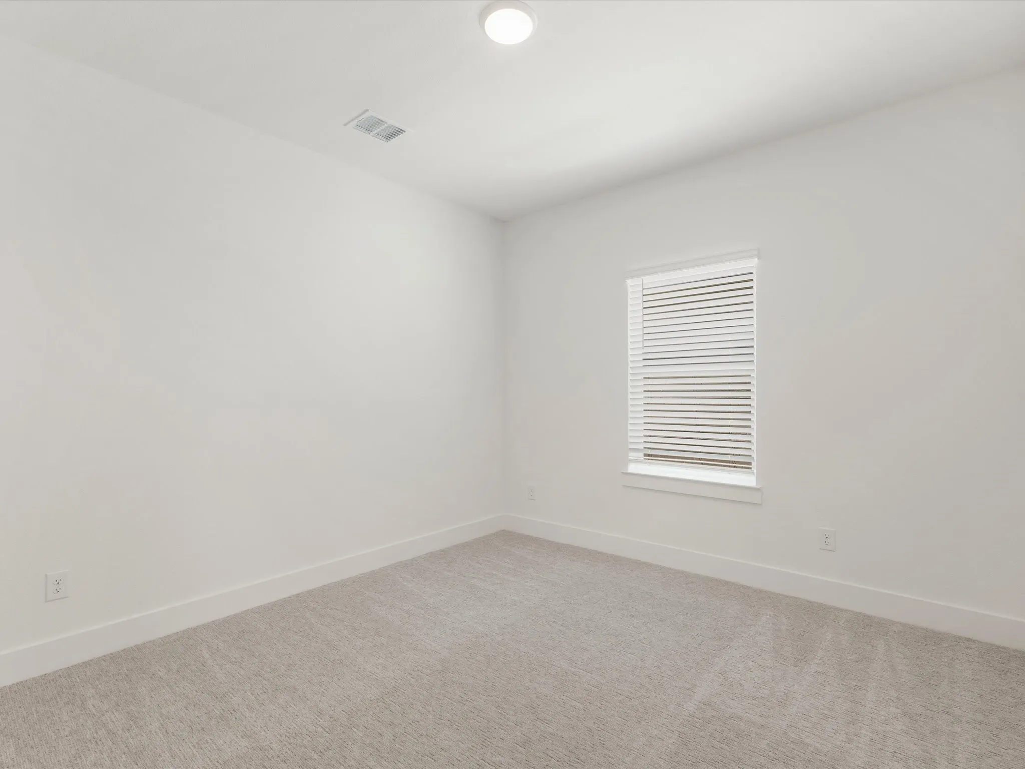 Bedroom 5 featuring baseboards and light colored carpet