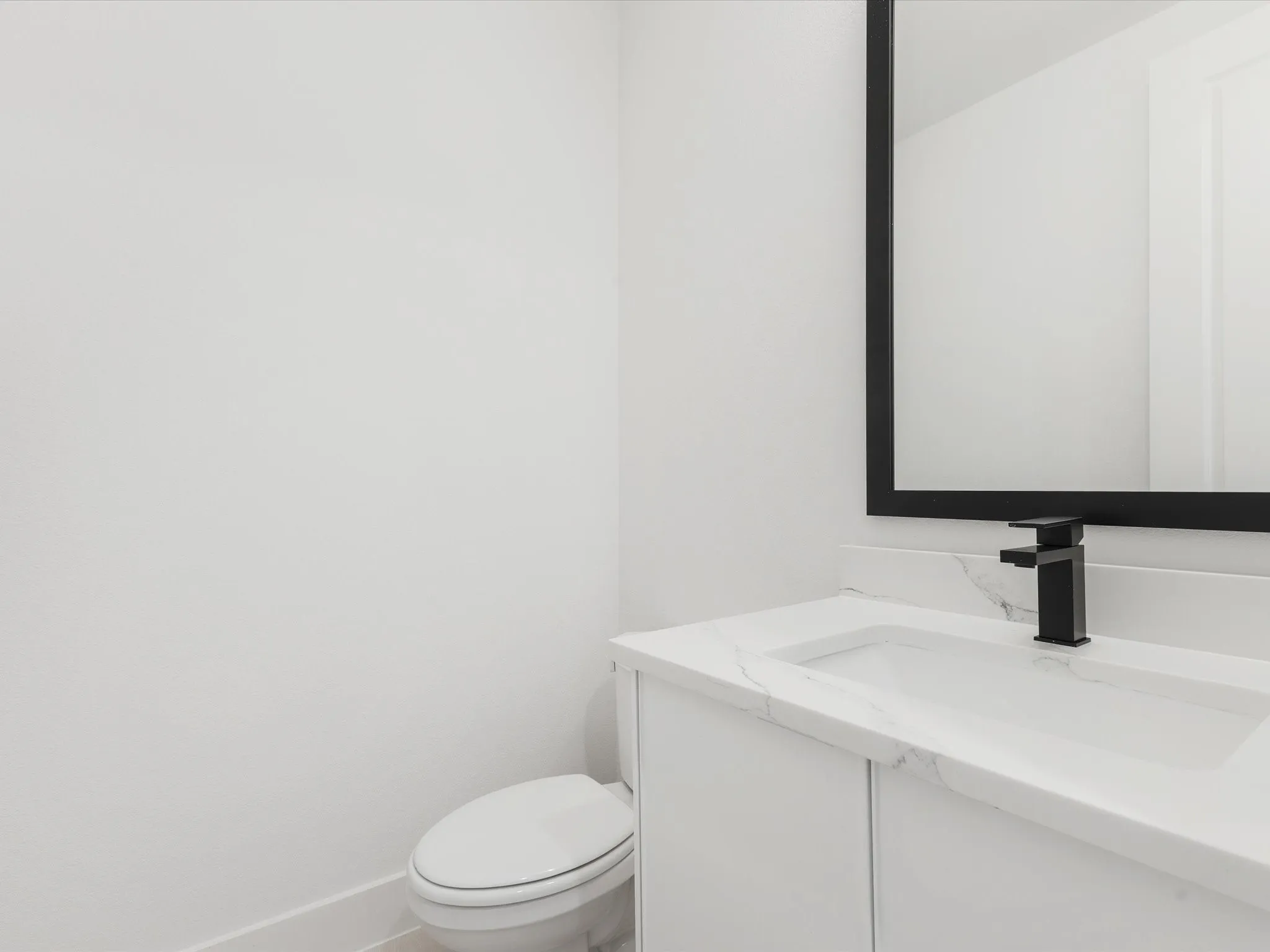 Half bath featuring vanity and toilet