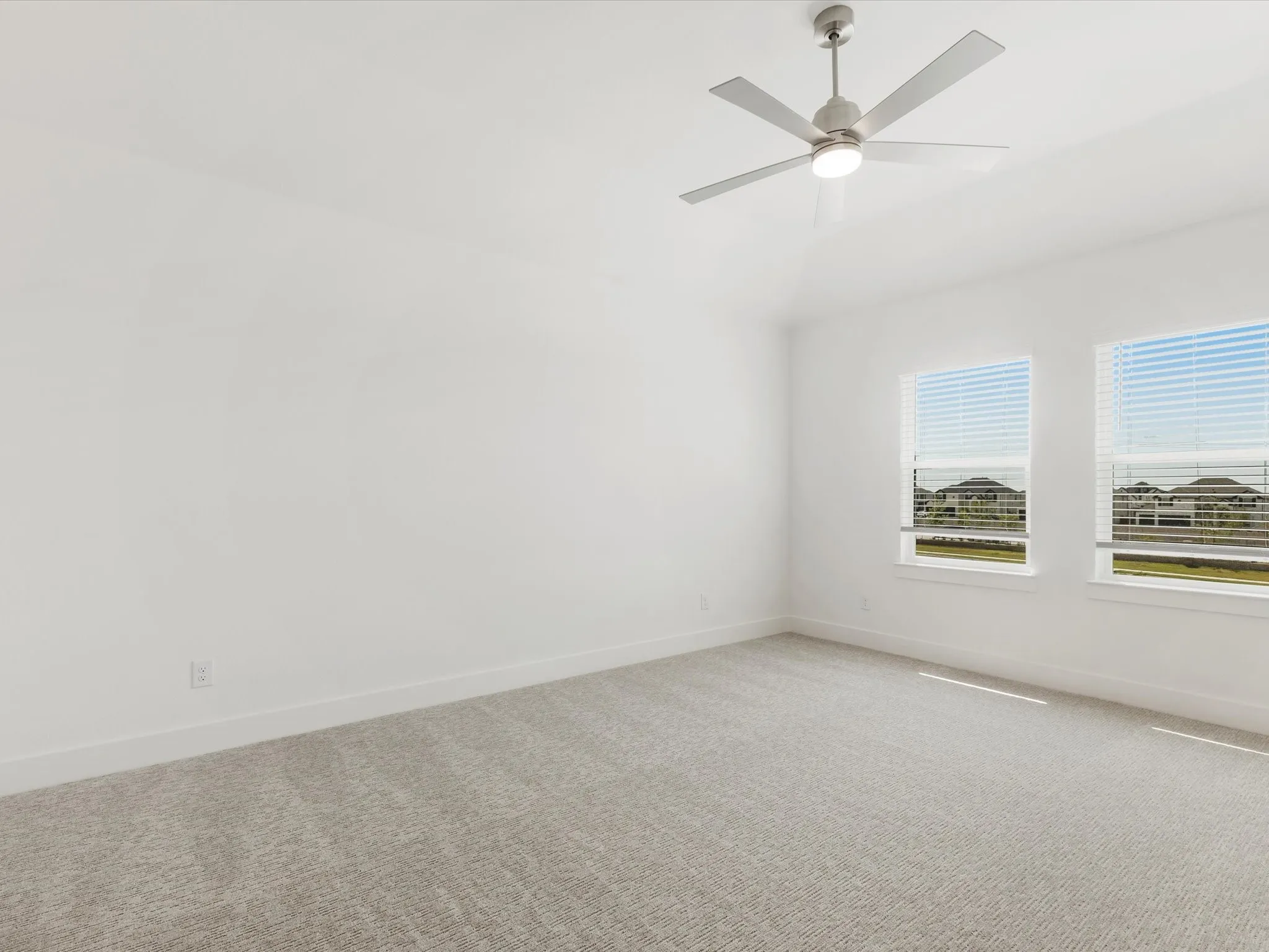 Primary bedroom room with carpet floors and ceiling fan