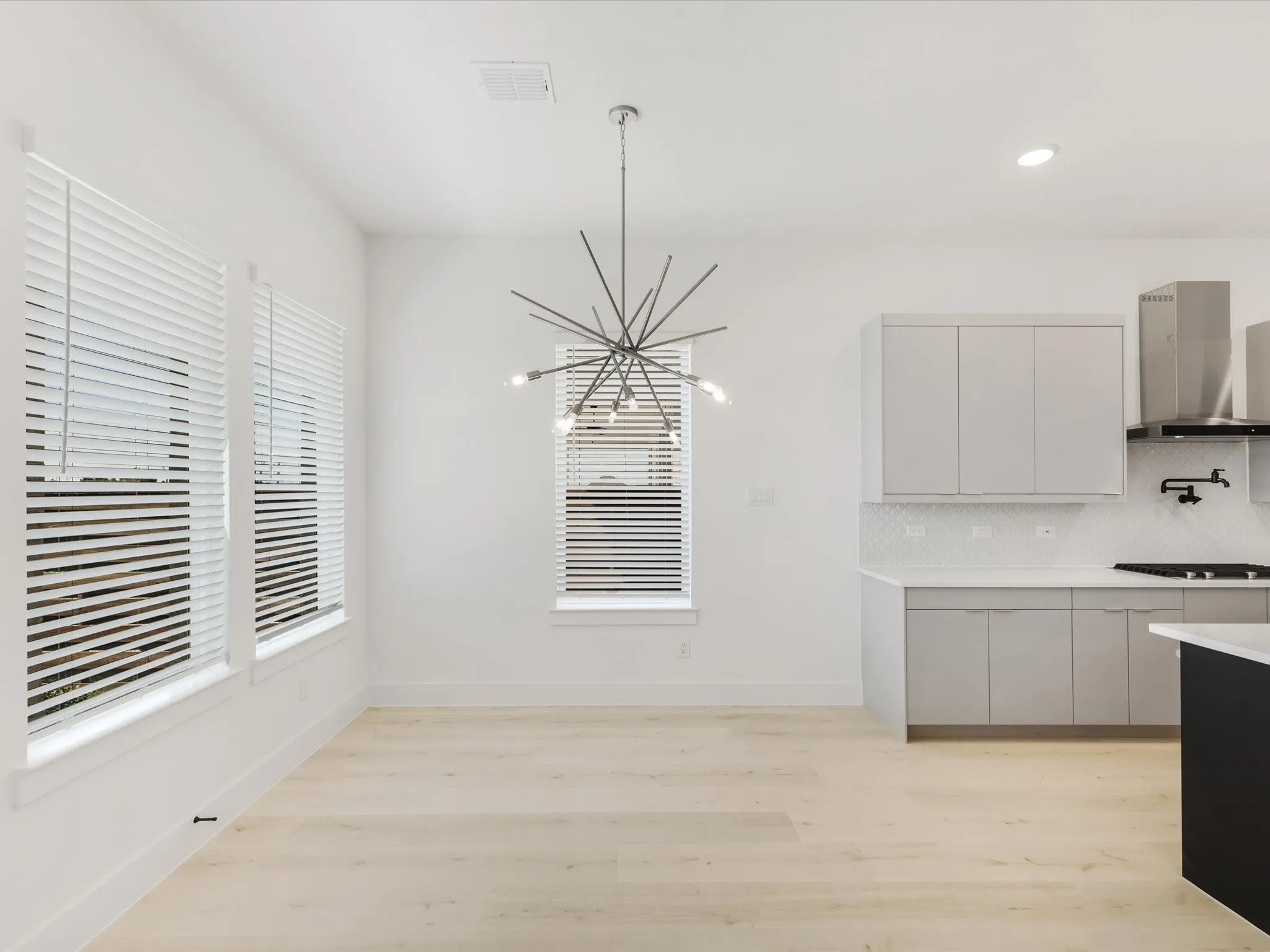Dining area featuring recessed lighting, light wood-style flooring, plenty of natural light, and a chandelier