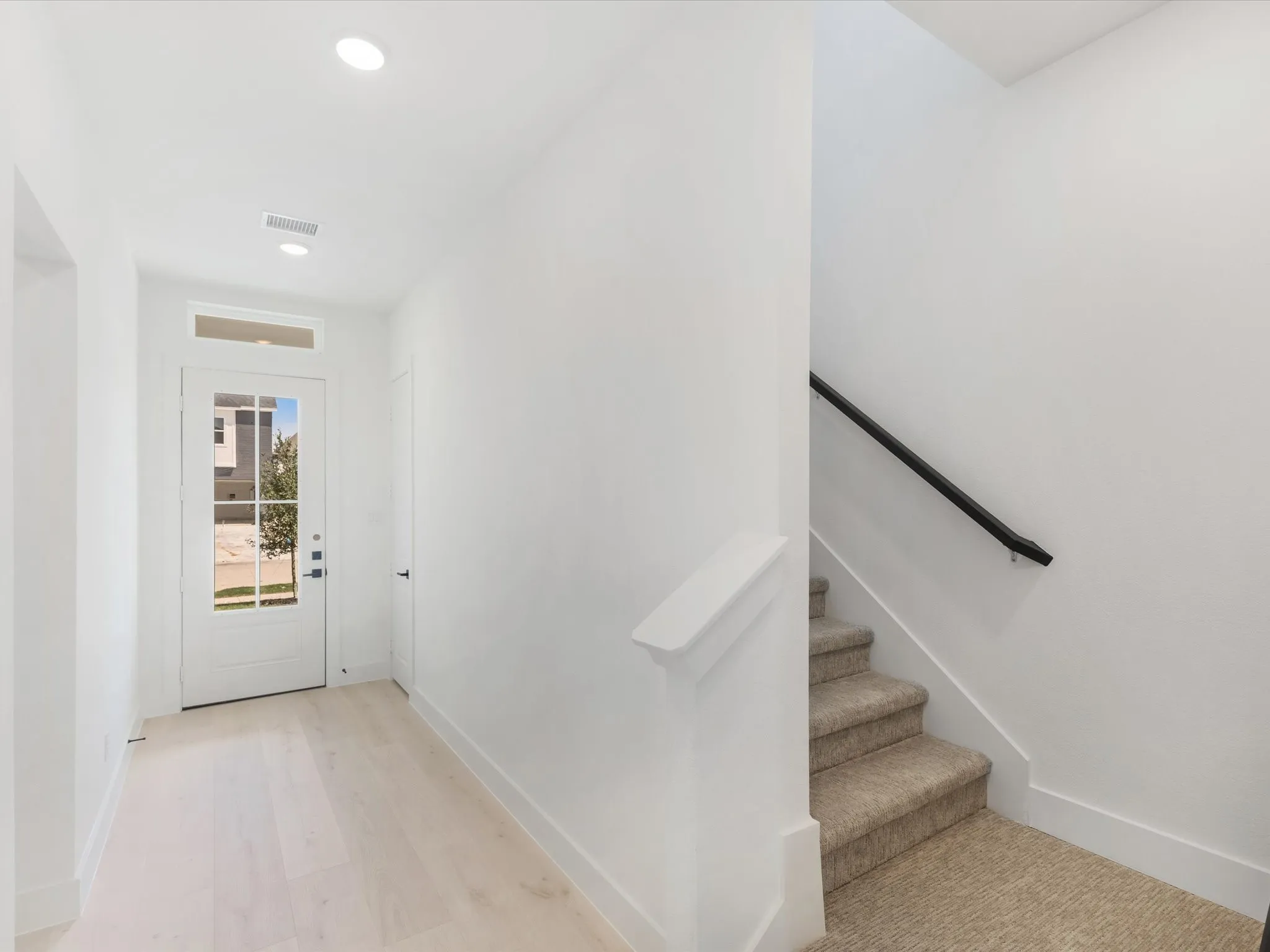 Stairway featuring recessed lighting and wood finished floors