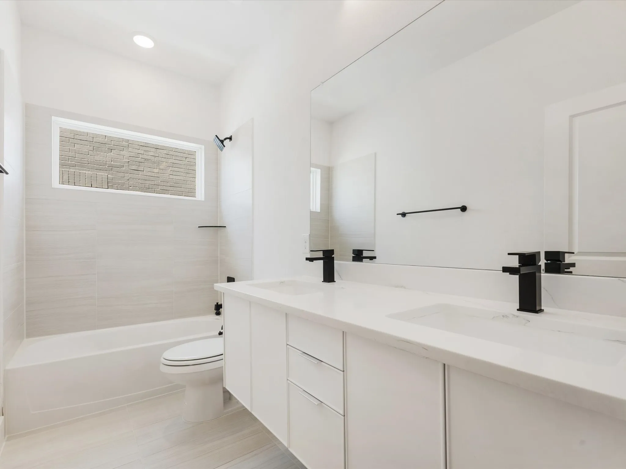 Bathroom 4 featuring dual sinks and floating cabinets