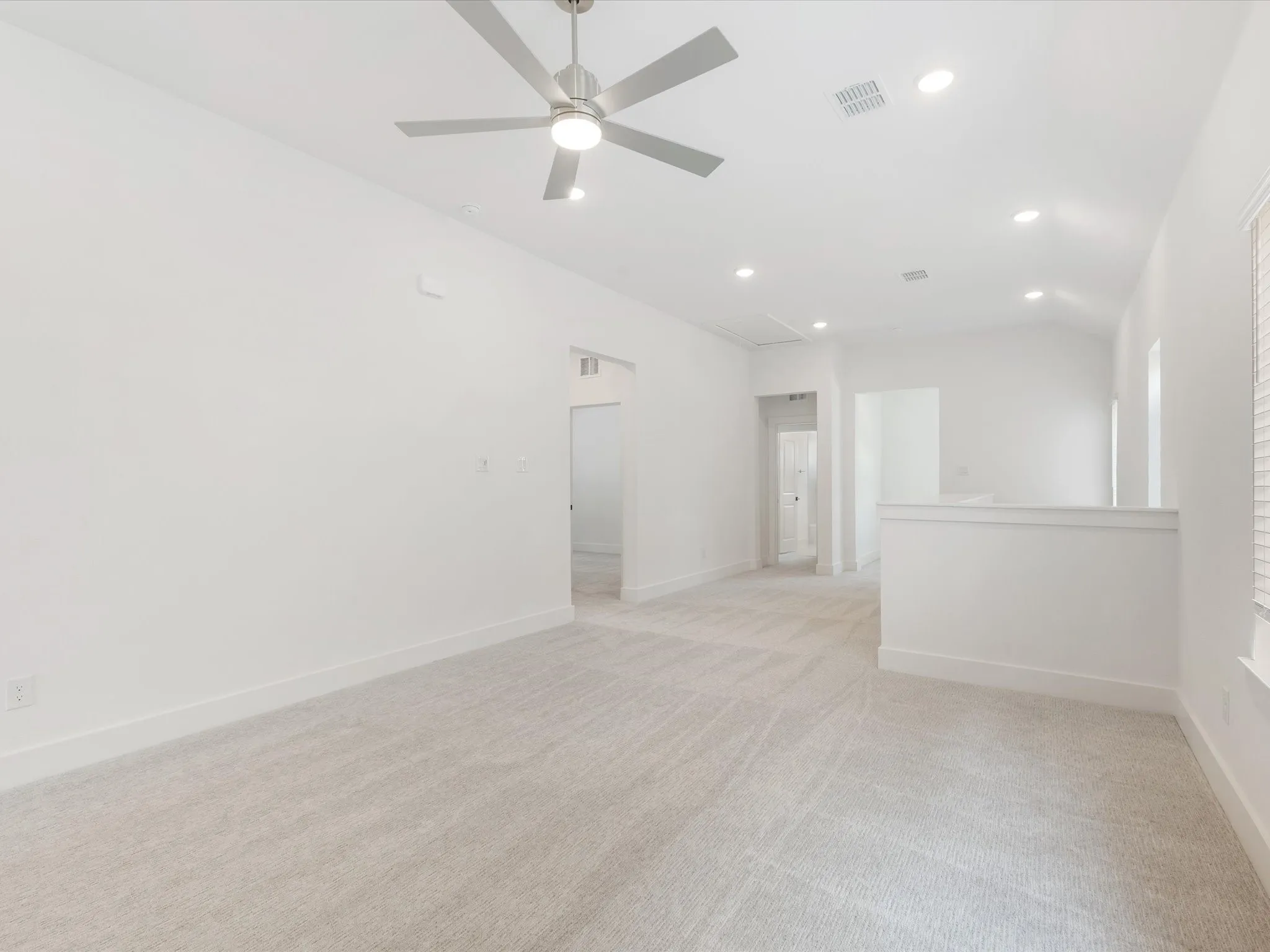 Large gameroom featuring light carpet, recessed lighting, and ceiling fan