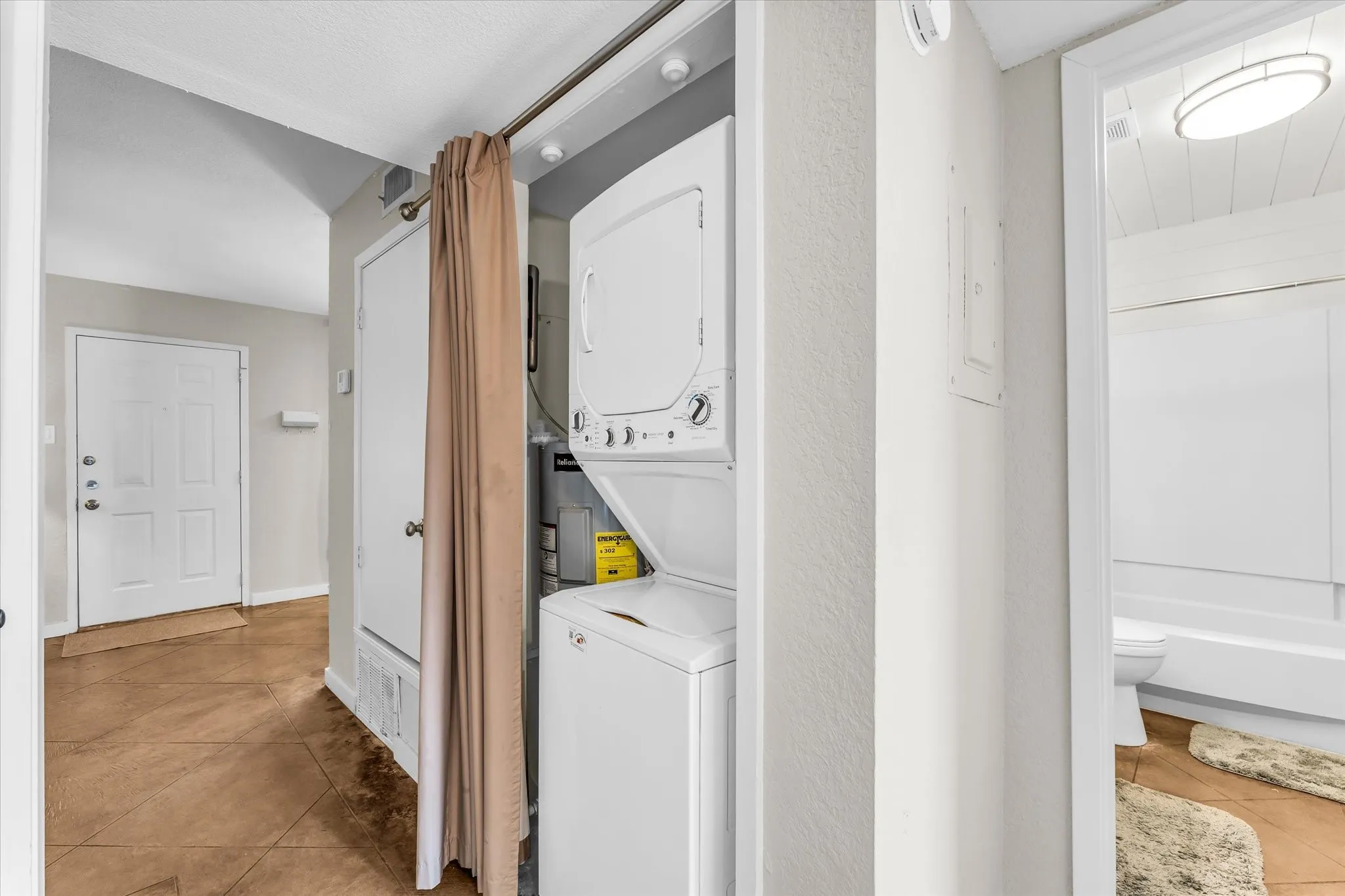 Stackable washer and dryer within a dedicated utility closet