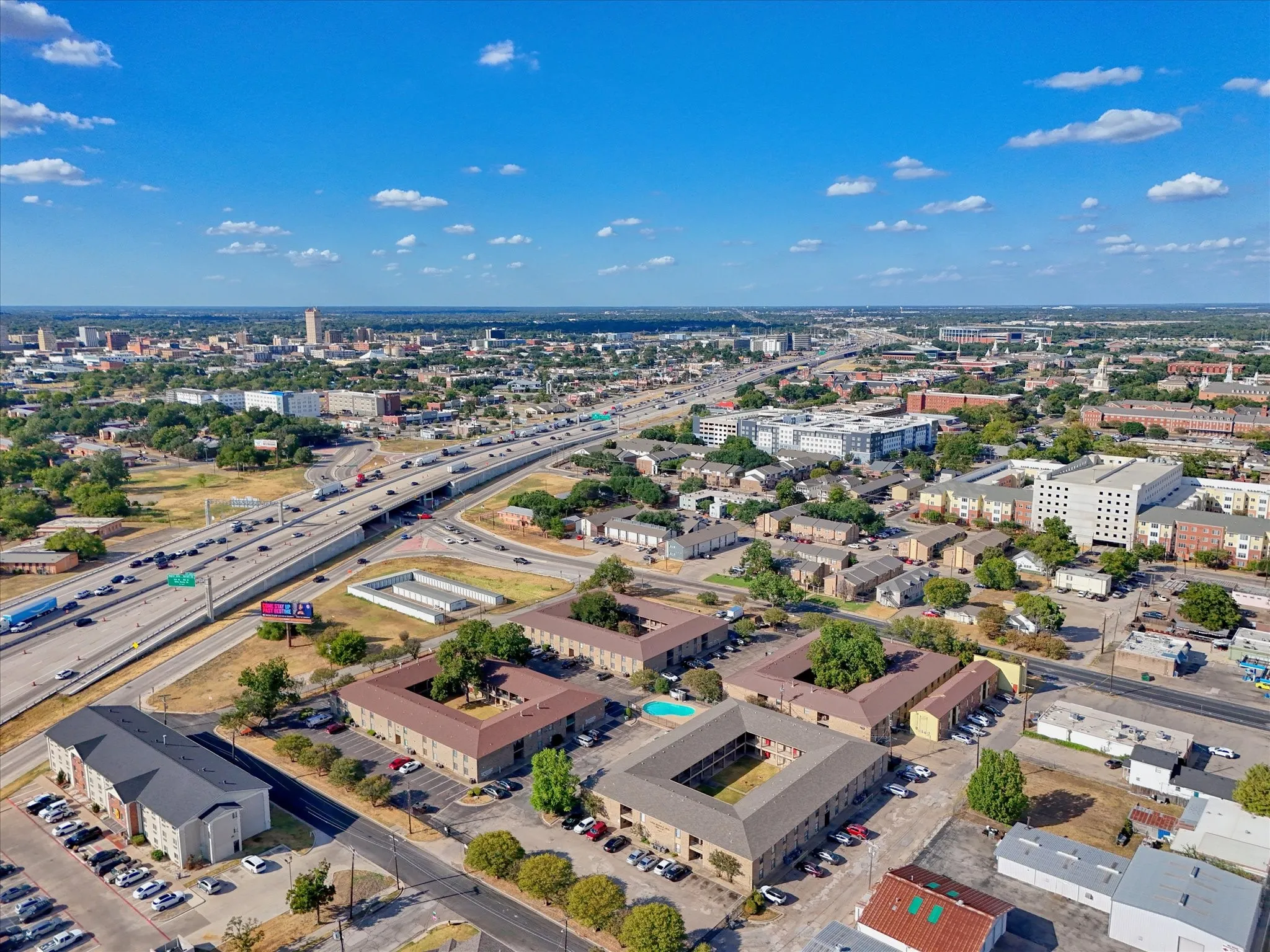 Expansive urban landscape featuring multi-lane highways and commercial structures
