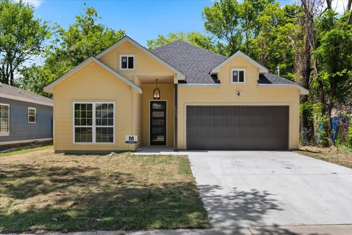Yellow siding exterior with a dark gray shingle roof