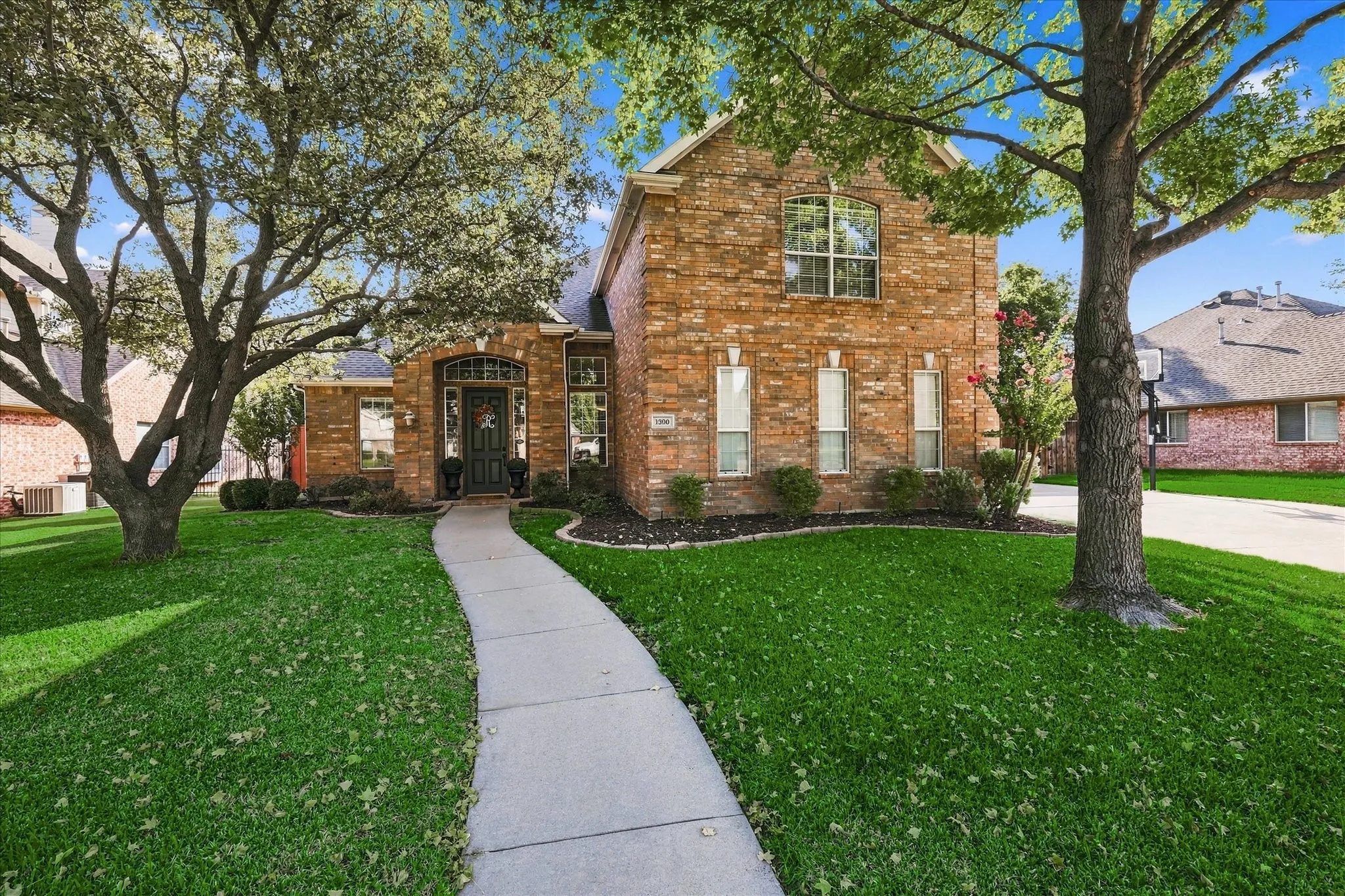 Two-story brick exterior with an arched entryway