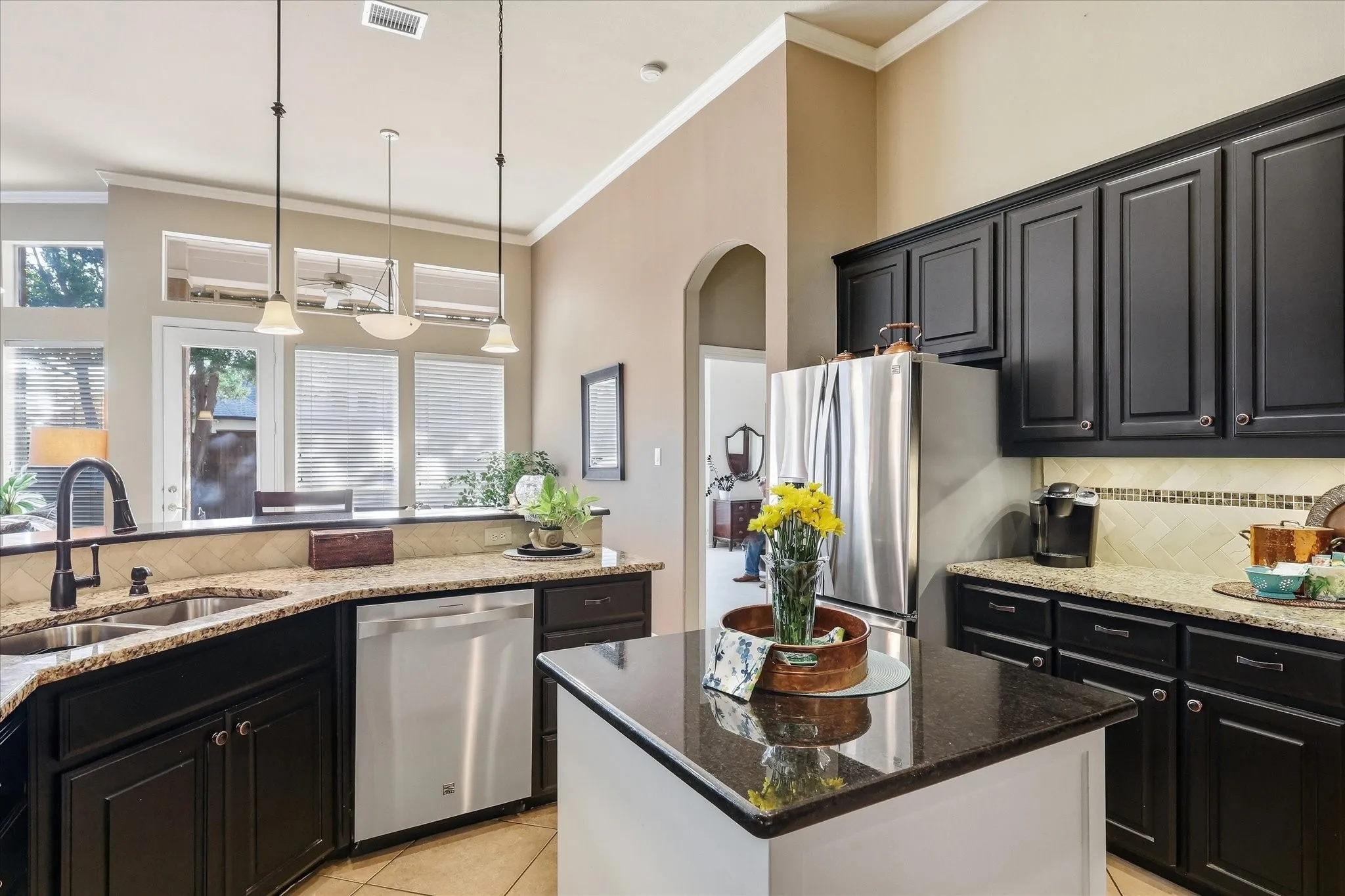 Spacious living area featuring high ceilings, extensive window array, ceramic tile flooring, and recessed lighting
