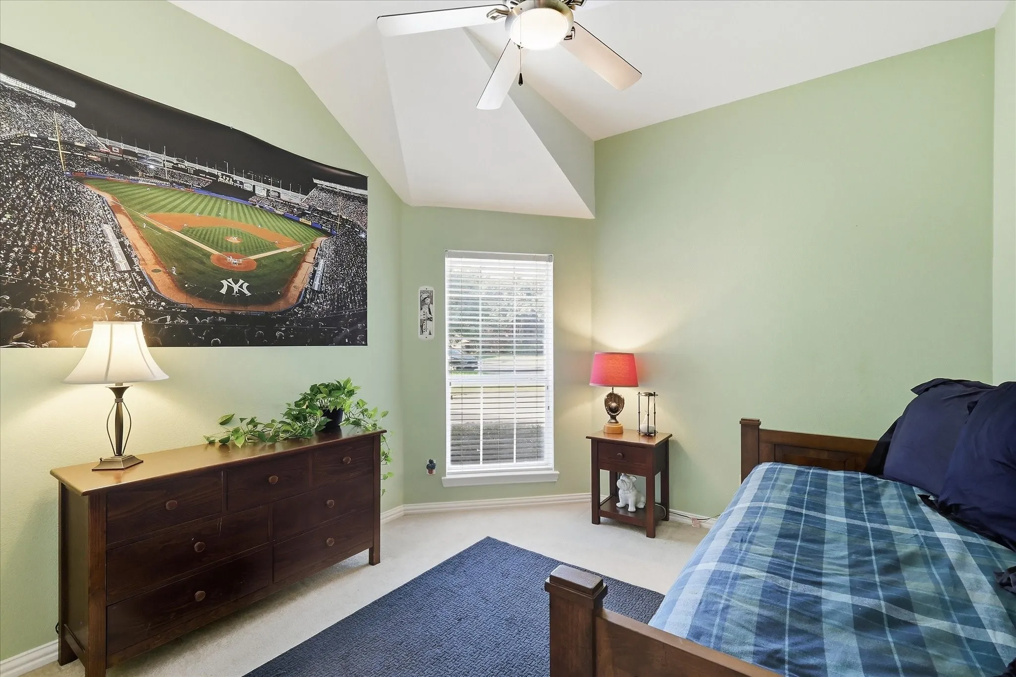Vaulted ceiling with an integrated light fixture, overhead shelving, and a hanging rod