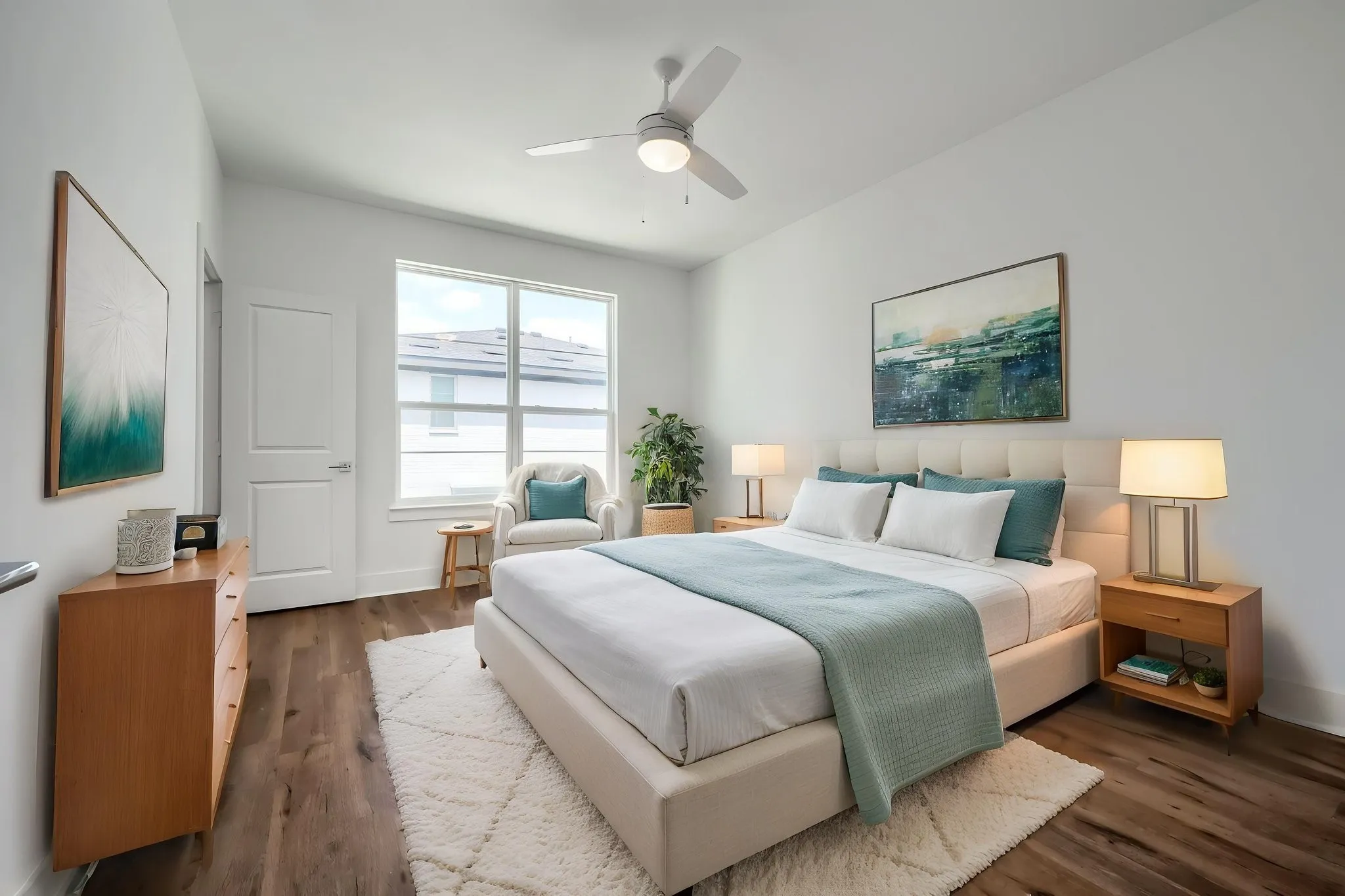 Vaulted ceiling with a ceiling fan, large window, wood-finish flooring, and a paneled door