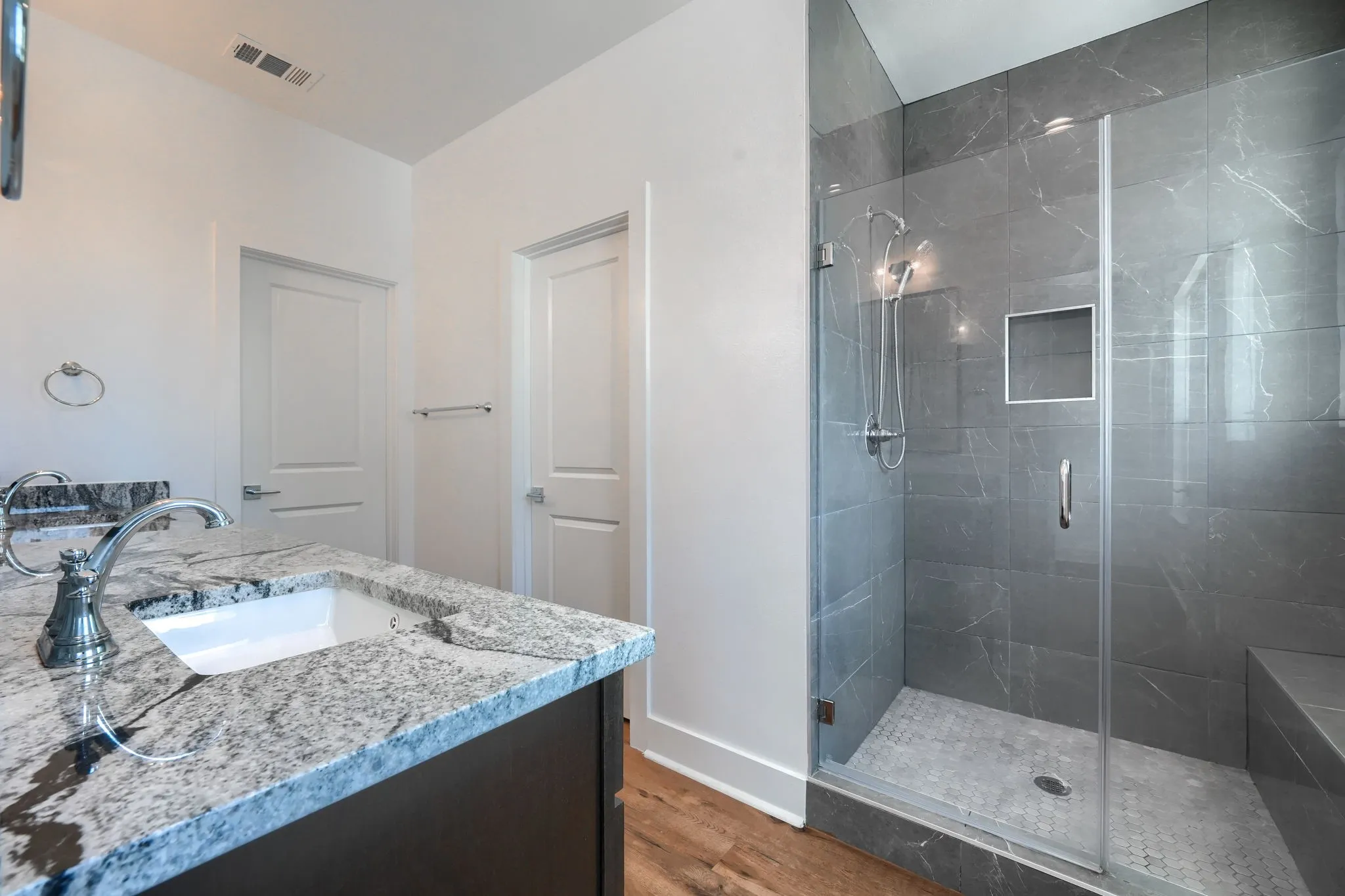 Double vanity with granite countertops, undermount sinks, and chrome faucets