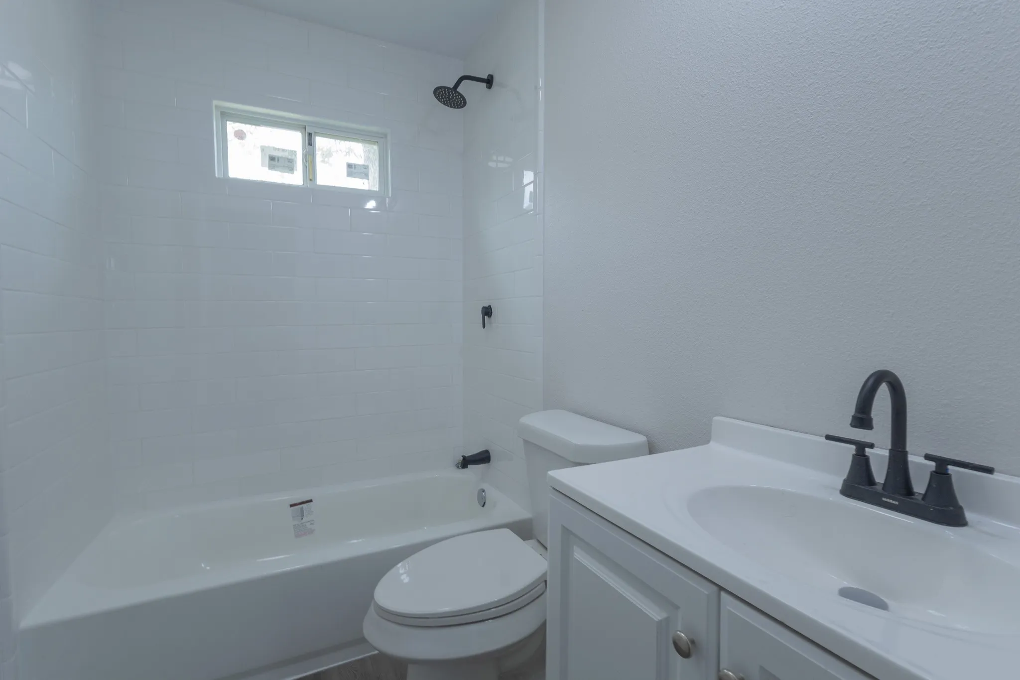 White subway tile shower surround with a built-in window