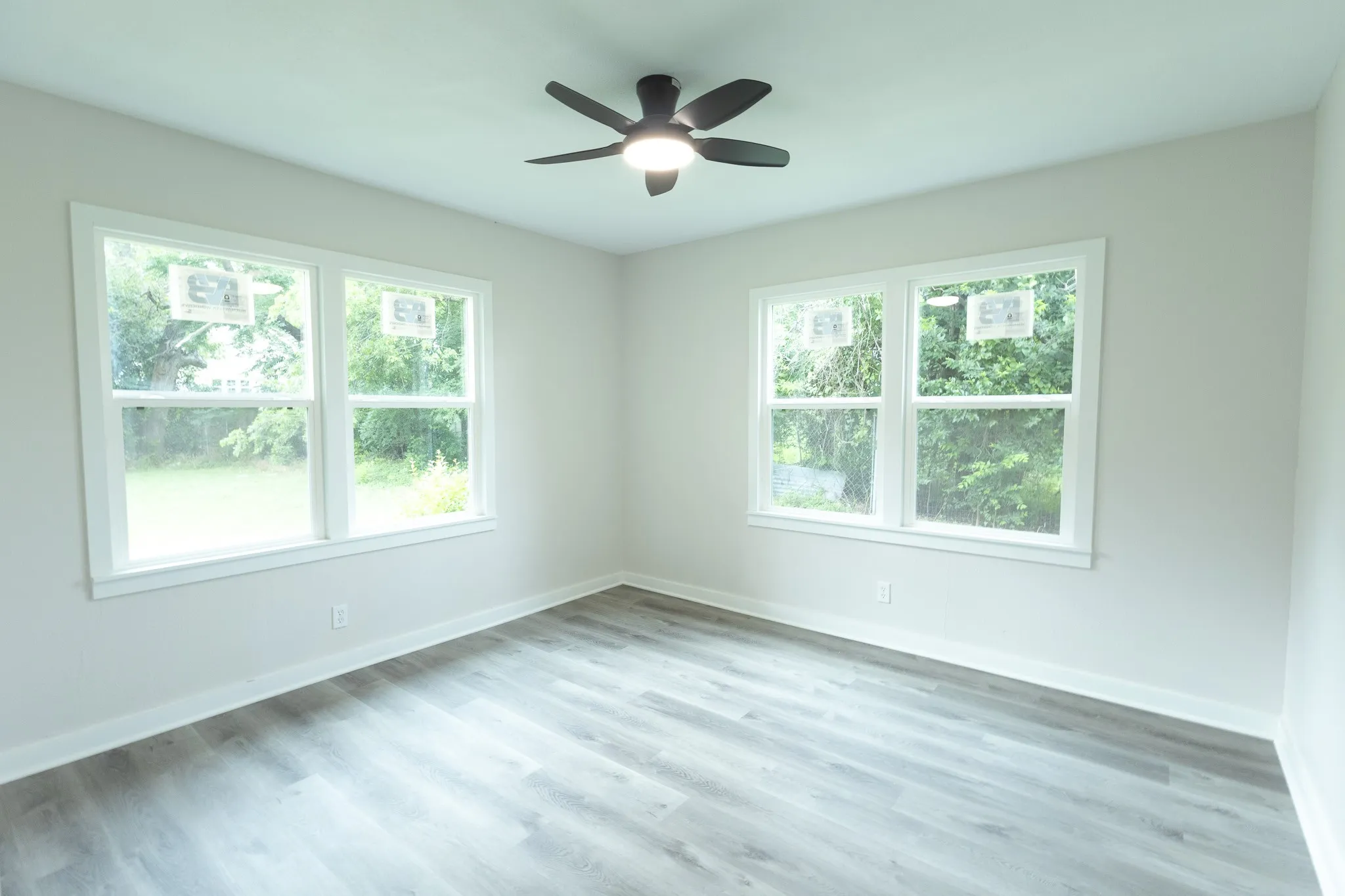 Light gray walls complement the wood-finish flooring