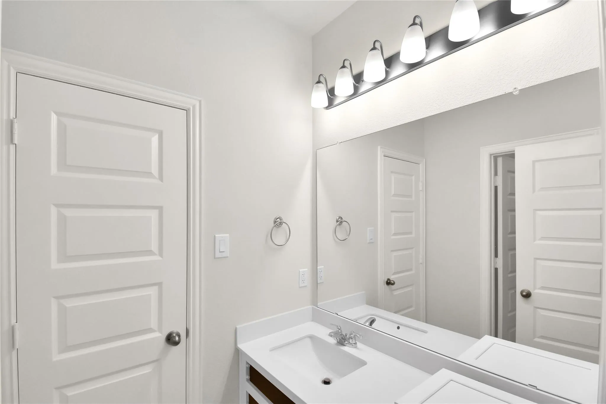 Full-width vanity mirror with a five-light fixture