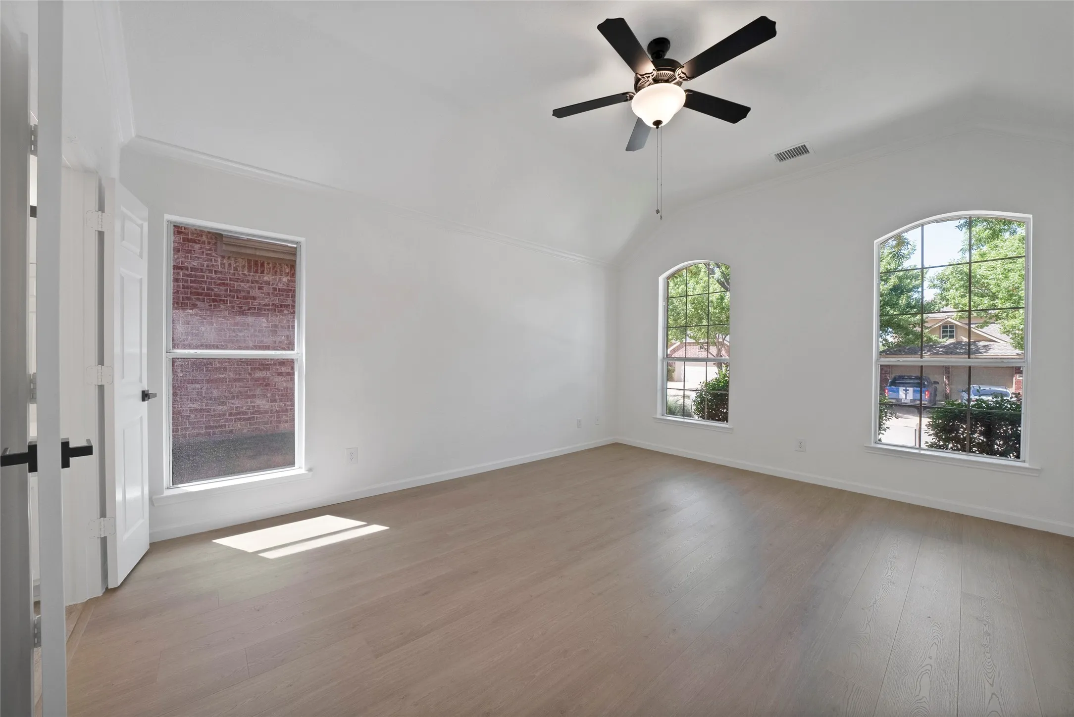 Good size primary bedroom with lots of windows.