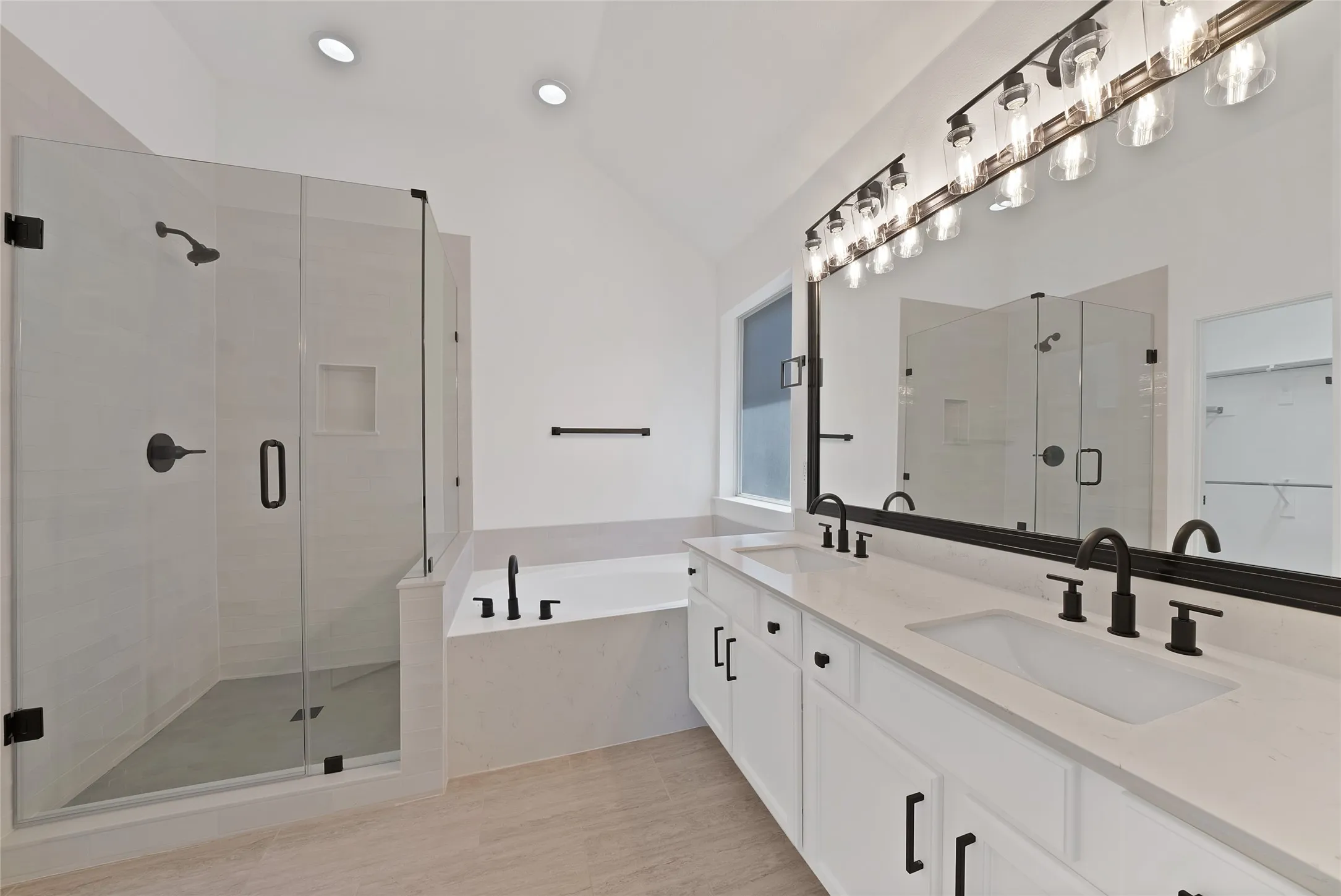 Beautiful spa-like back boasts quartz counter tops, painted cabinets with hardware, dual sinks, relaxing garden tub, updated shower with seamless glass enclosure, new plumbing fixtures and lighting.