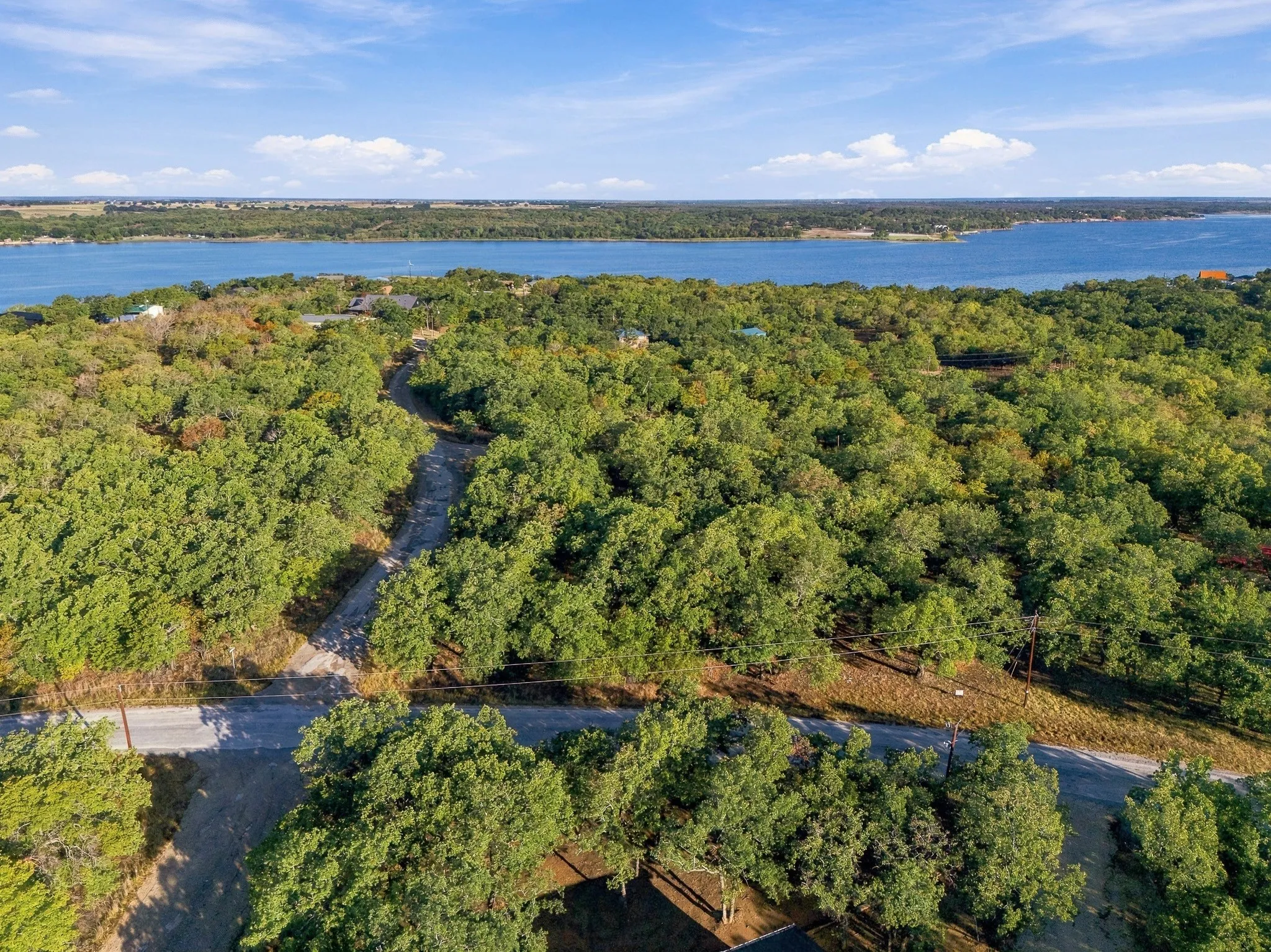 Wooded property with water body in the background