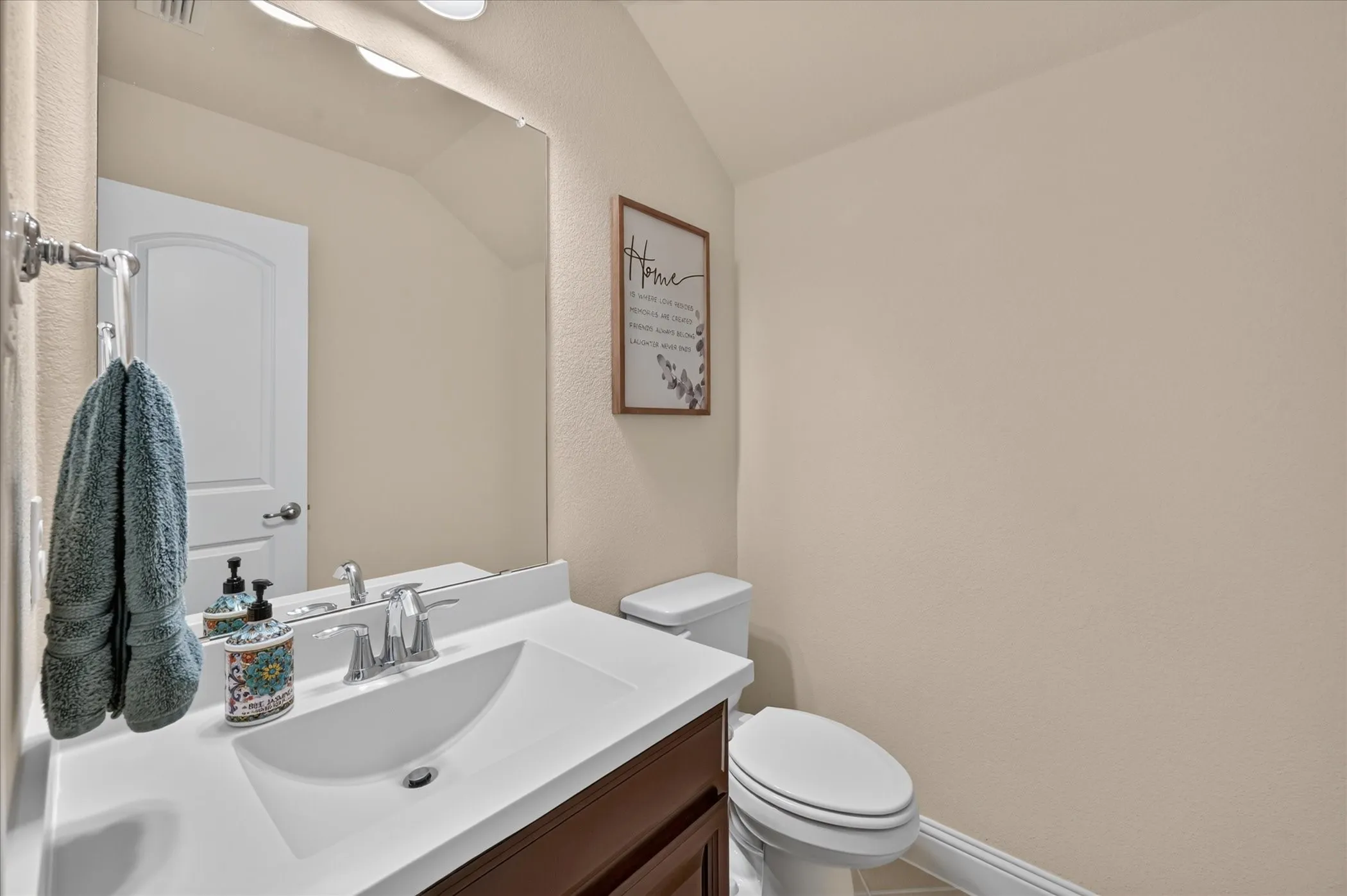 Built-in vanity with integrated sink, chrome faucet, and dark wood-finish cabinetry