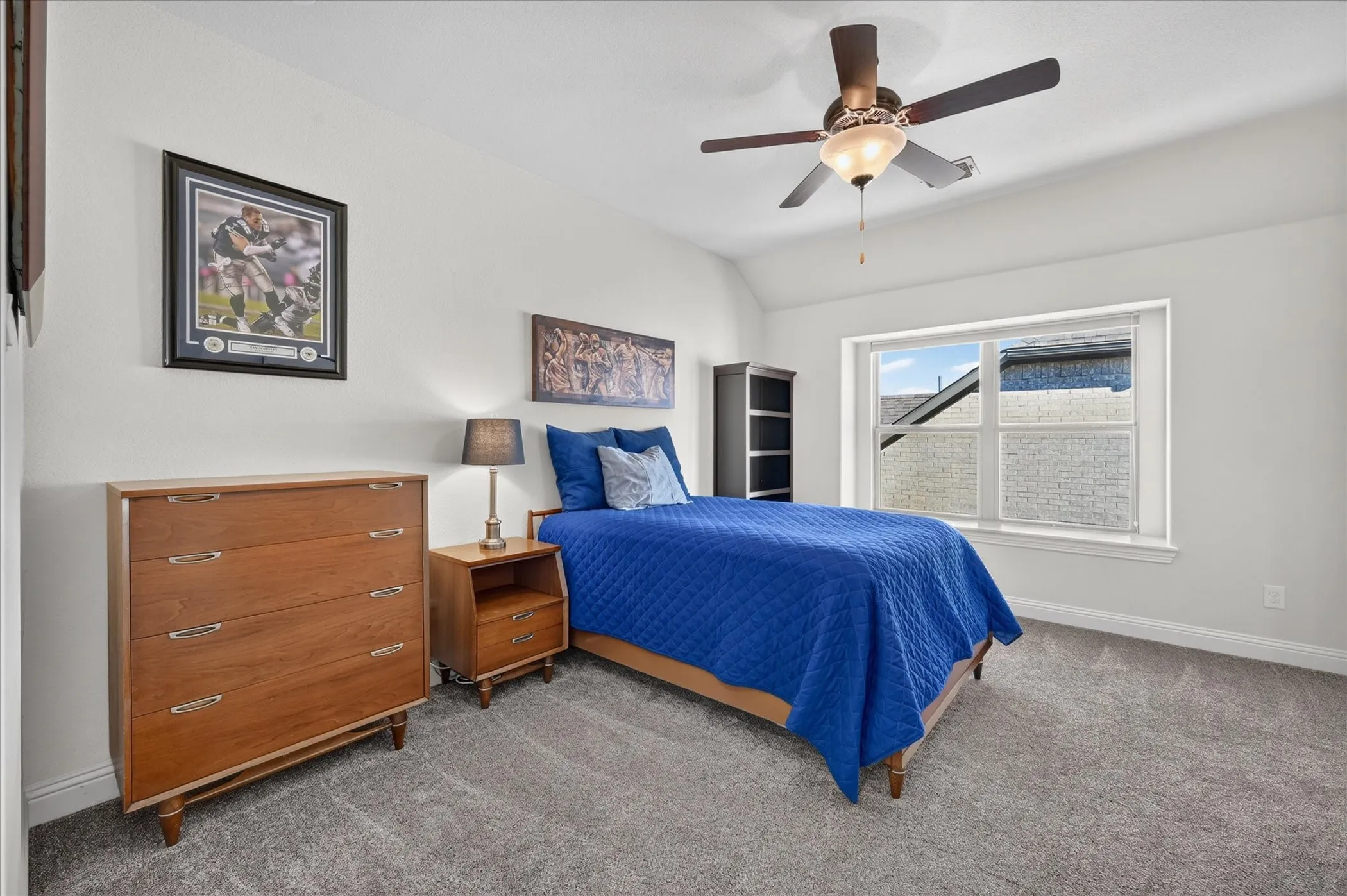 Recessed window, ceiling fan with integrated lighting, and carpeted flooring