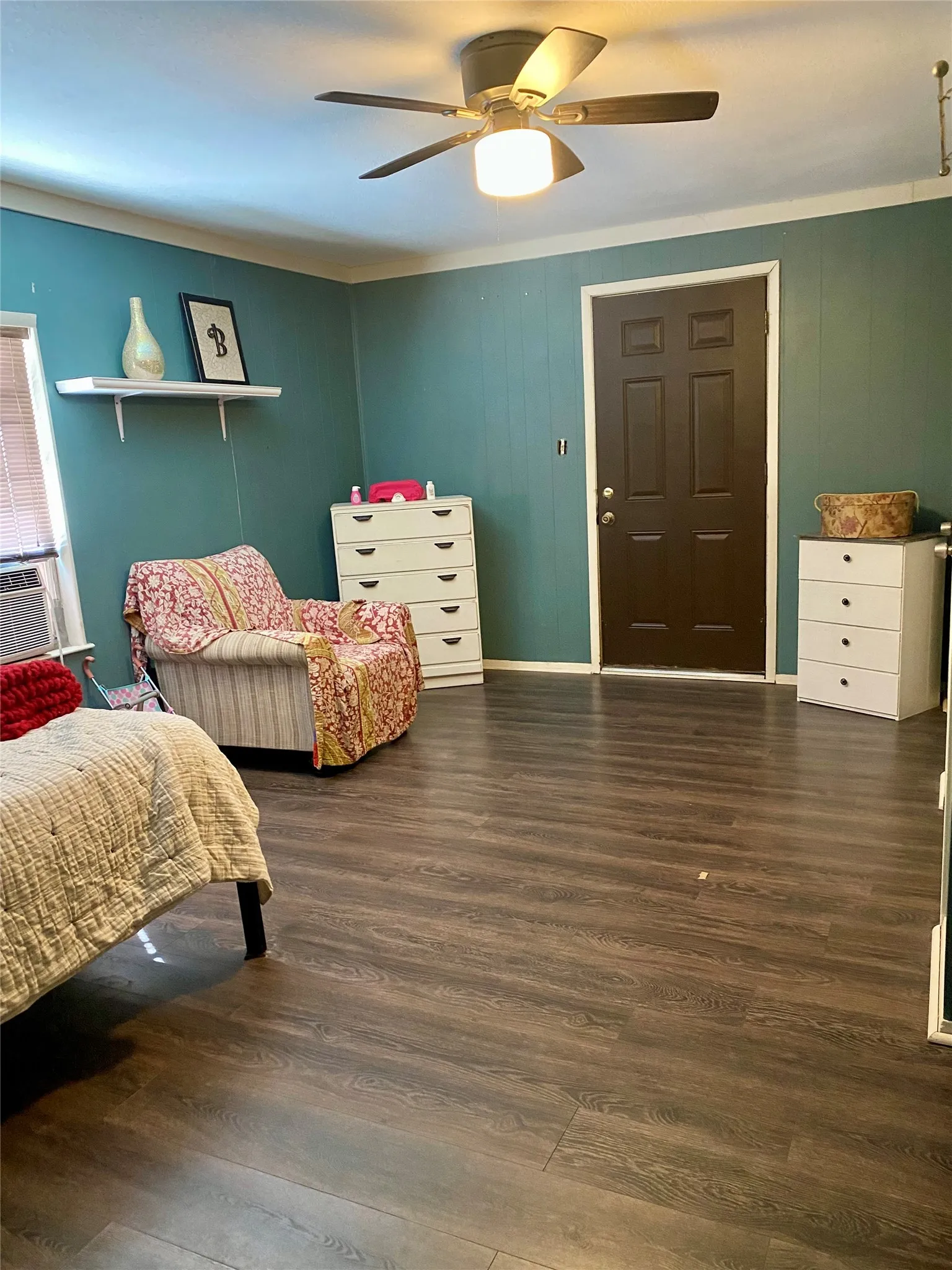 Bedroom with crown molding, and wood finished floors