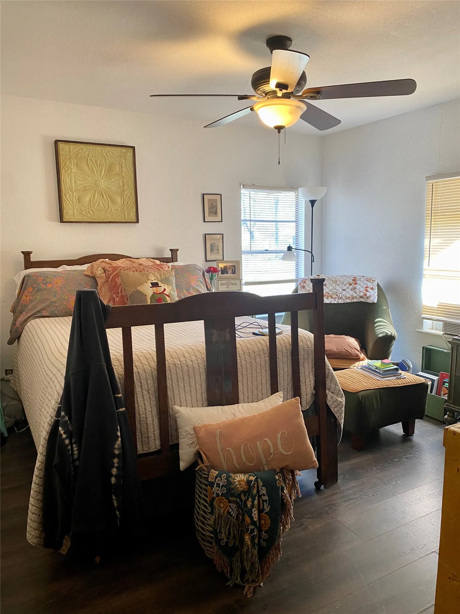 Bedroom with wood finished floors, and a ceiling fan