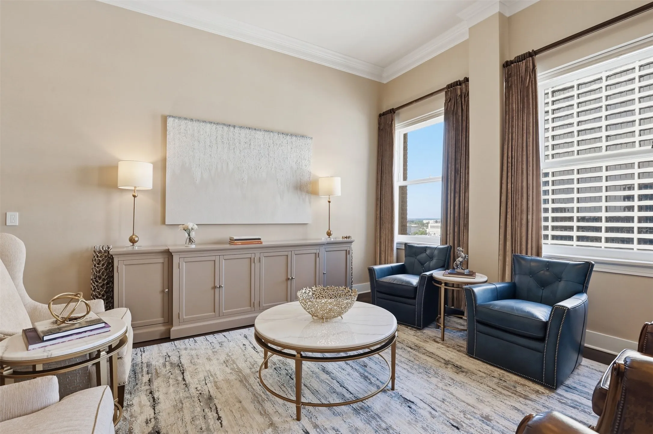 Crown molding details, neutral wall tones, large double-hung windows, and a built-in console cabinet