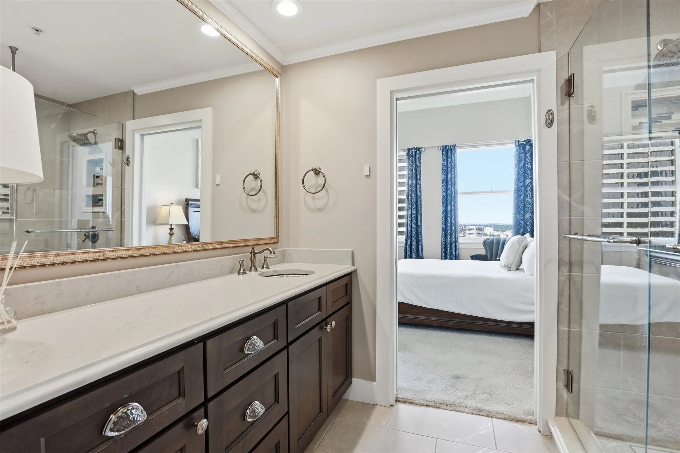 Dark wood vanity with a light-toned countertop, undermount sink, and polished chrome​​‌​​​​‌​​‌‌​‌‌​​​‌‌​‌​‌​‌​​​‌​​ faucet