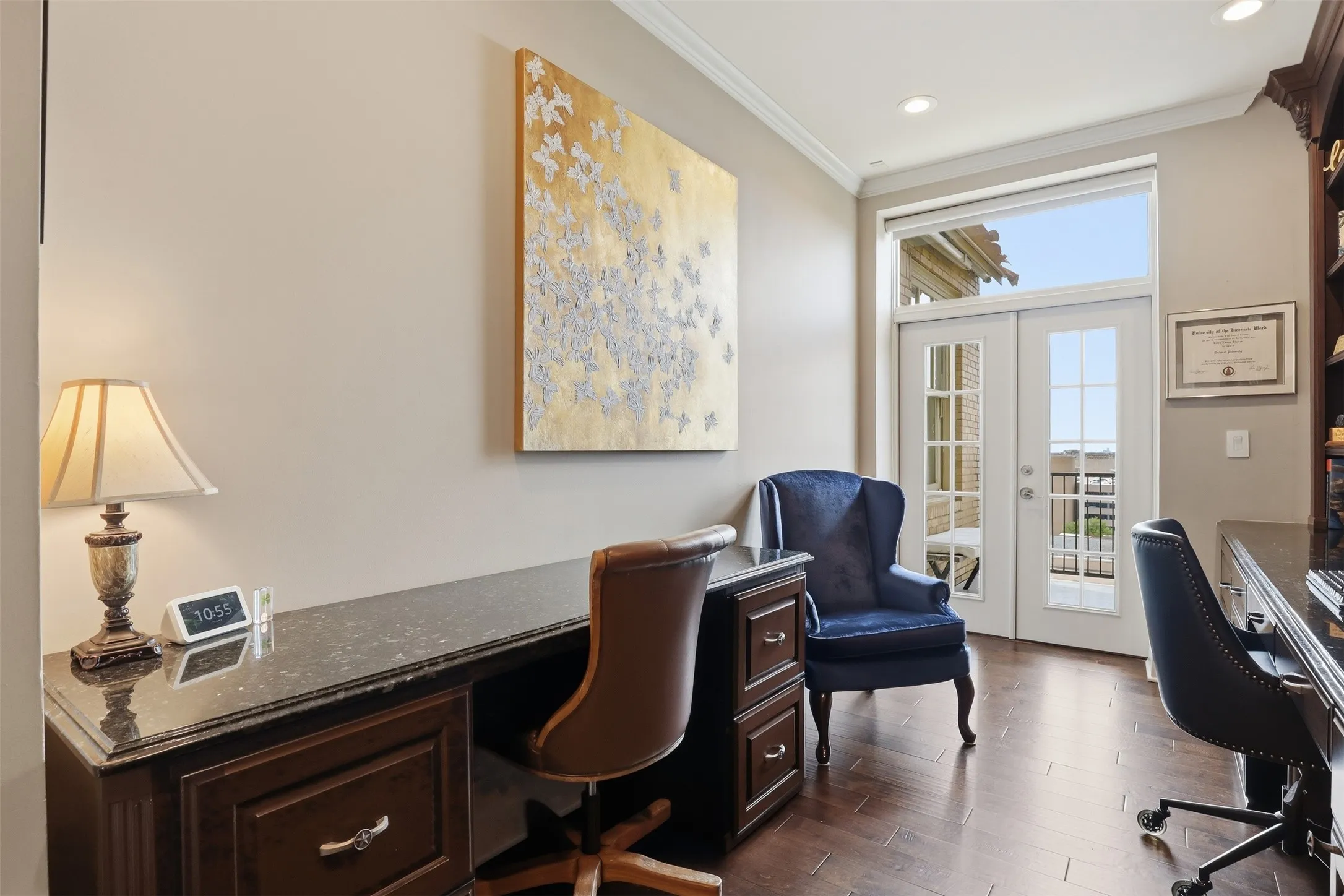 French doors with transom window, rich wood-finish flooring, built-in desk with dark countertop, built-in shelving, and crown molding