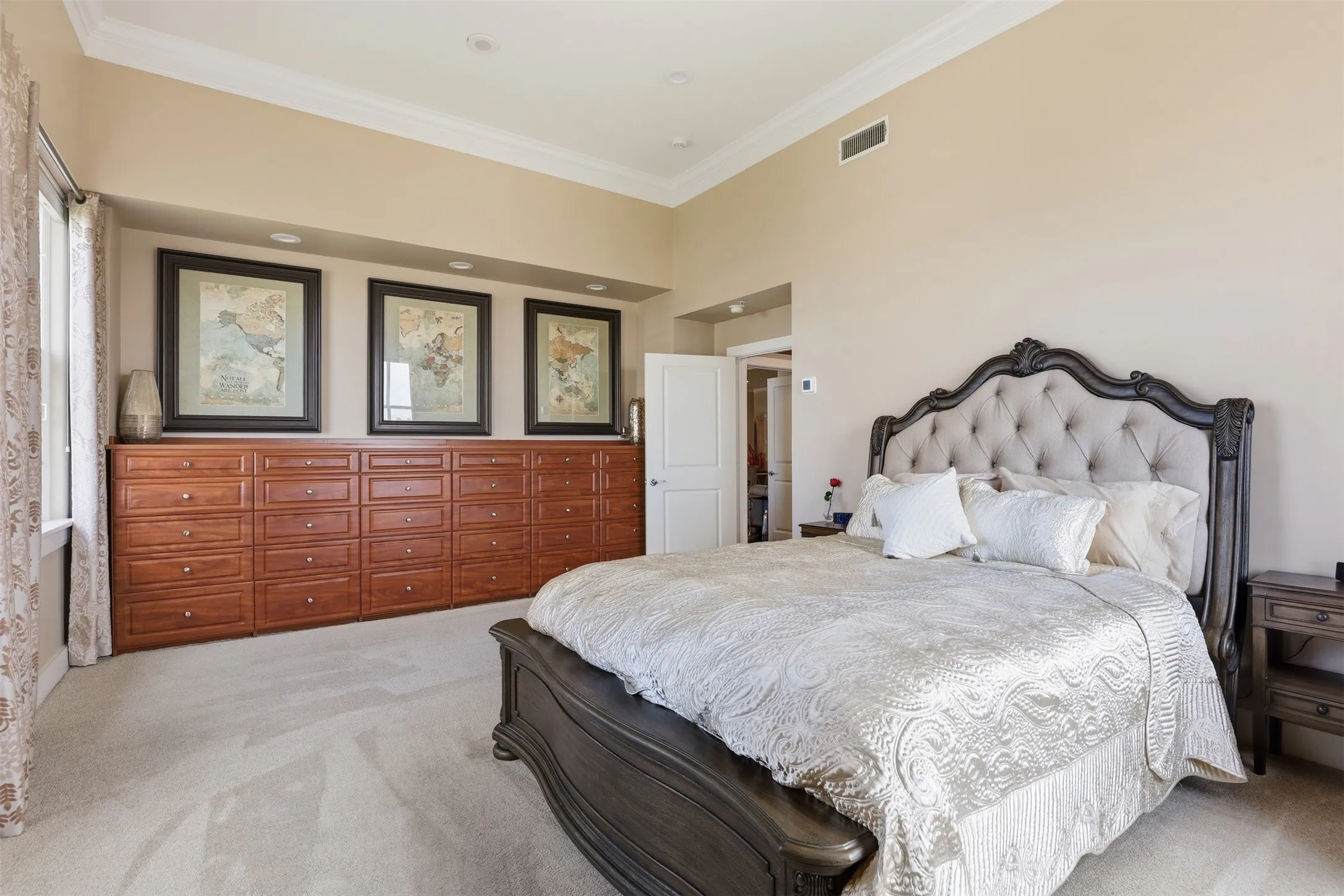 Built-in wood cabinetry with ample drawer storage, recessed lighting, and crown molding