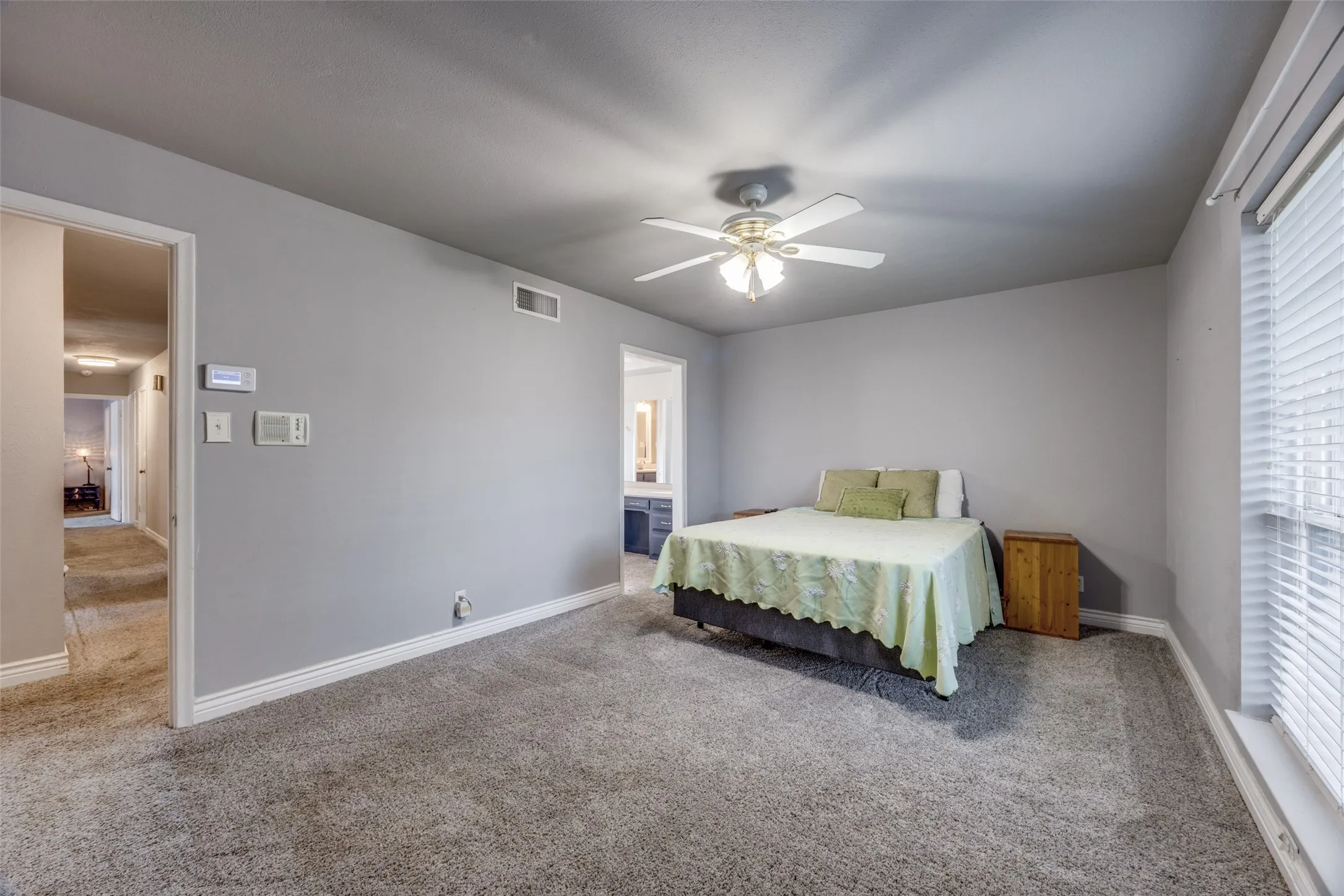 Wall-to-wall carpeting and neutral gray walls