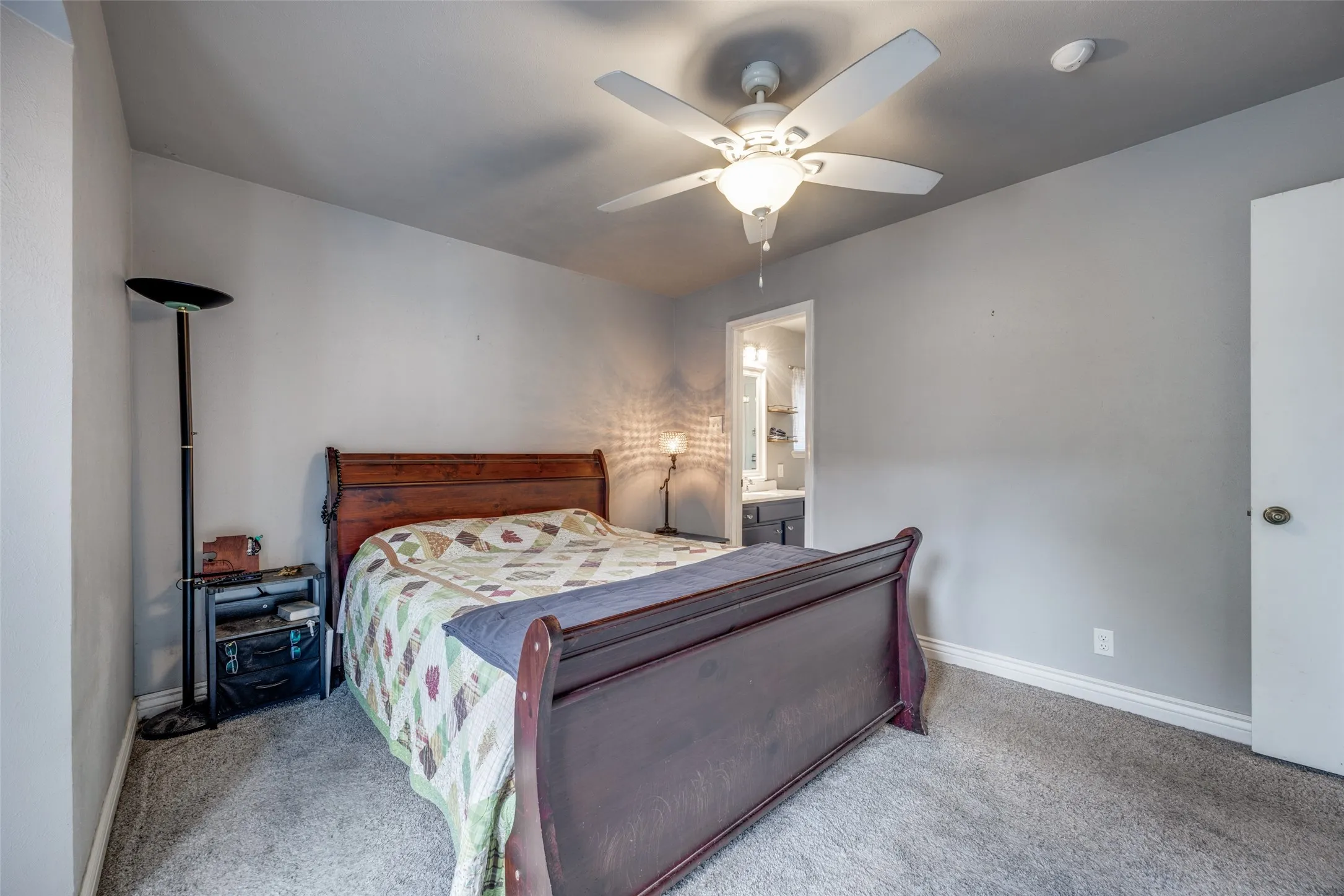 Carpeted flooring, ceiling fan with integrated lighting, and neutral wall tones