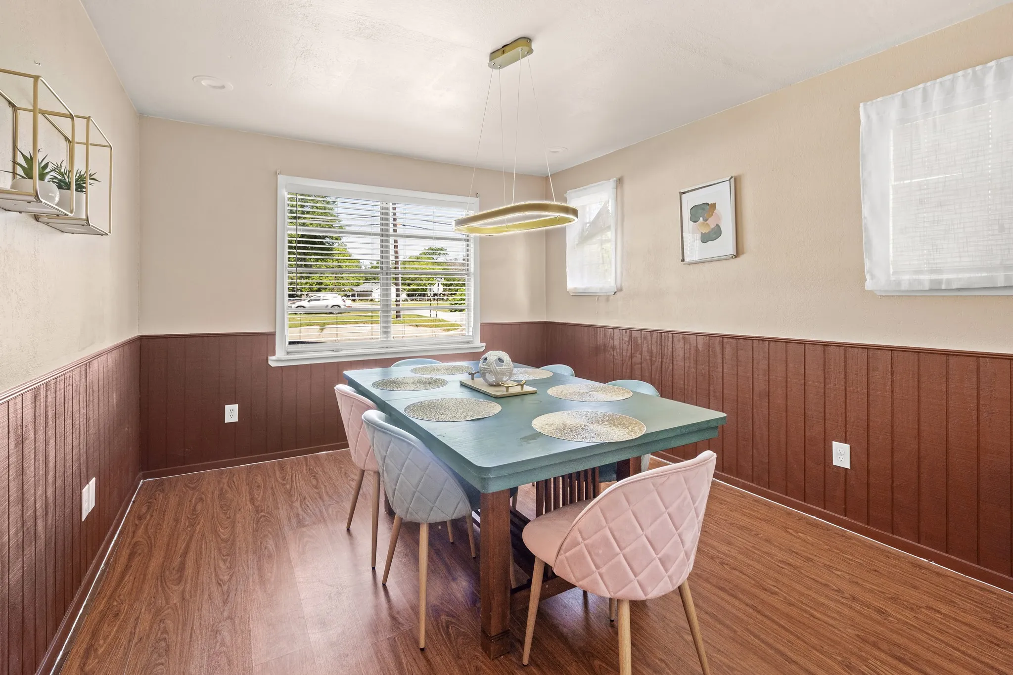 Wood-finish flooring, paneled wainscoting, and a central windows