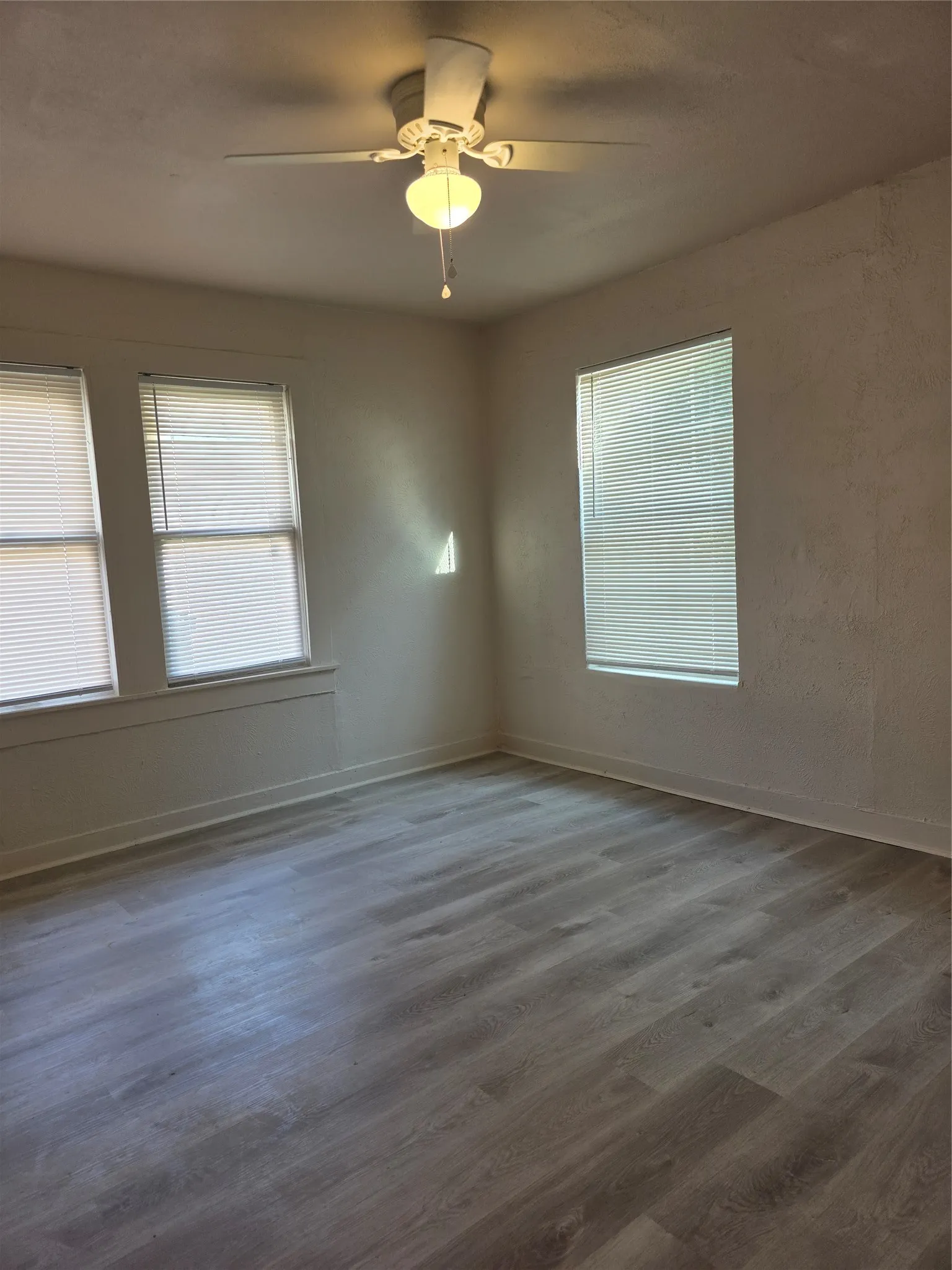 Recessed lighting, ceiling fan with light fixture, wood-finish flooring, multiple windows, window blinds