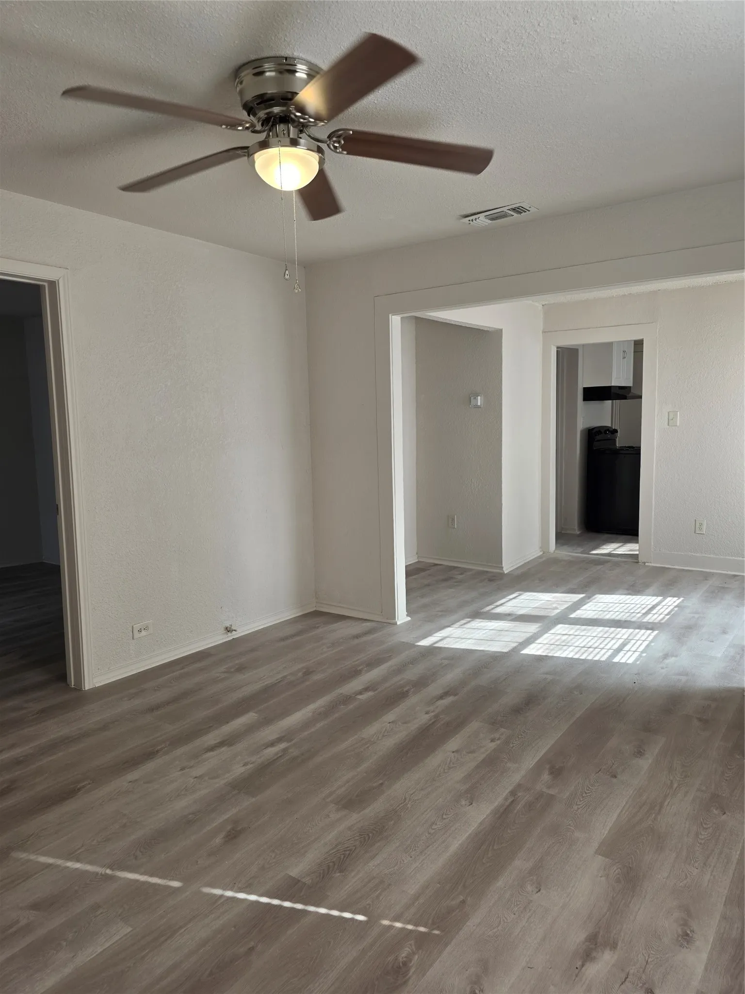 Neutral wall tones complement wood-finish flooring