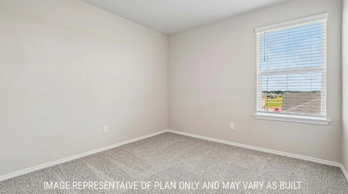 Carpeted room with a single window featuring horizontal blinds