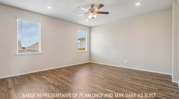 Wood-finish flooring, two windows with blinds, recessed lighting, and a ceiling fan with integrated light
