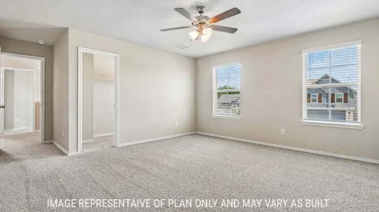 Carpeted room with a ceiling fan, two windows with blinds, and neutral wall tones