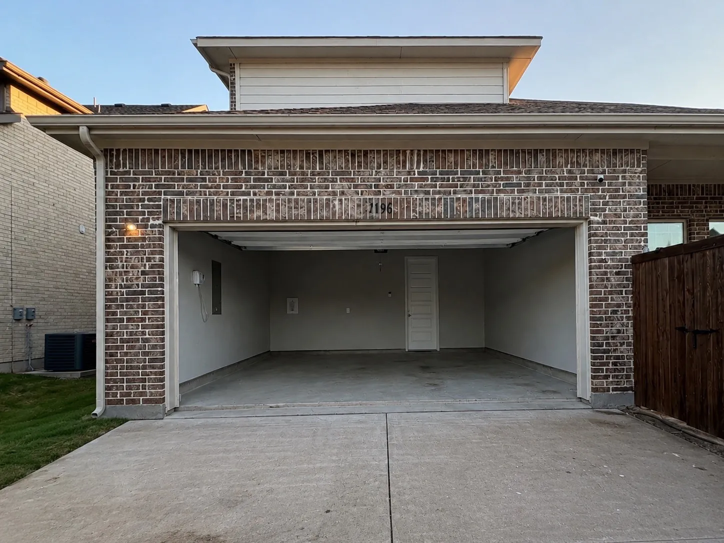 Attached two-car garage with a concrete driveway