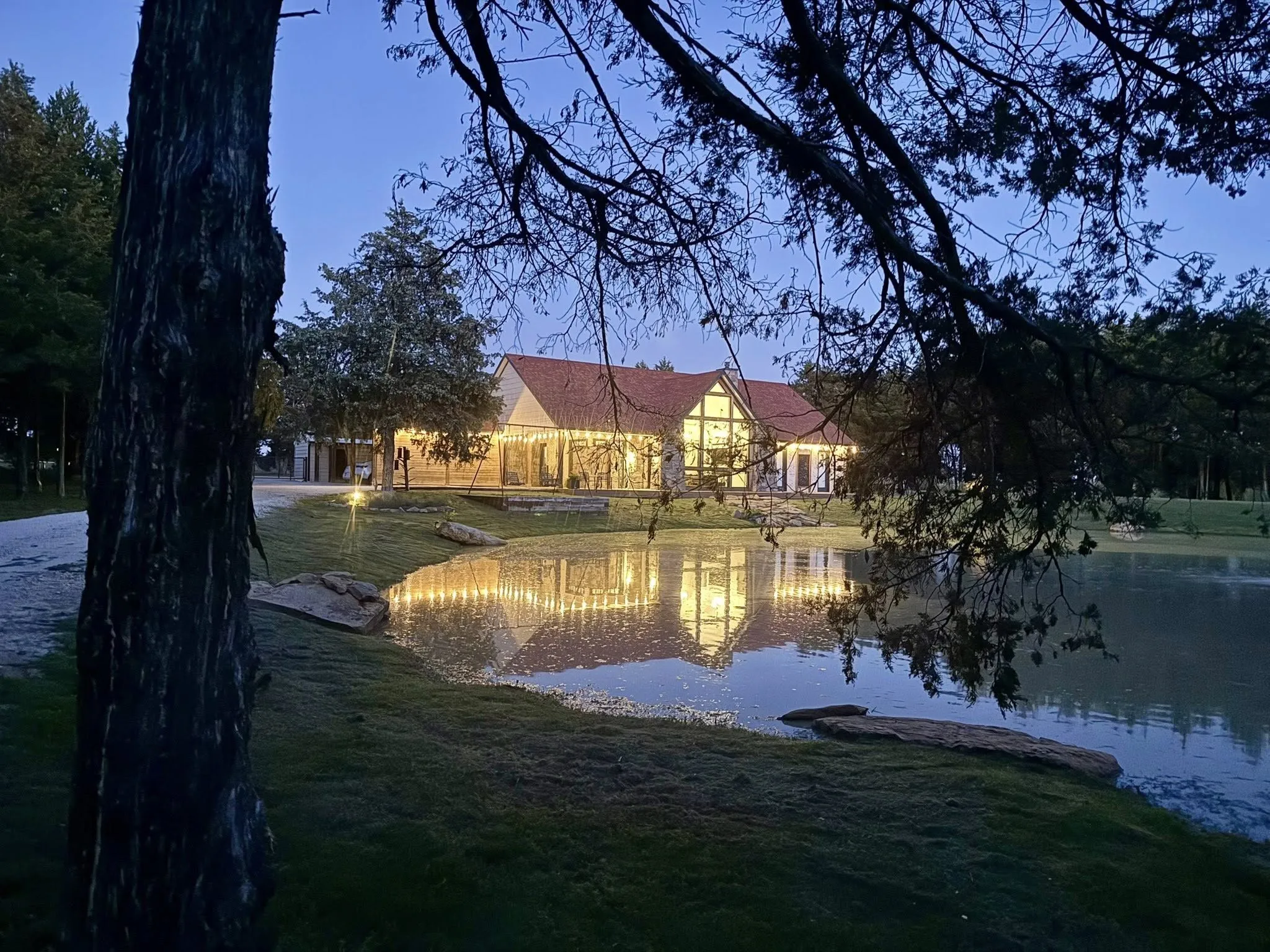 Night-time view of home and pond