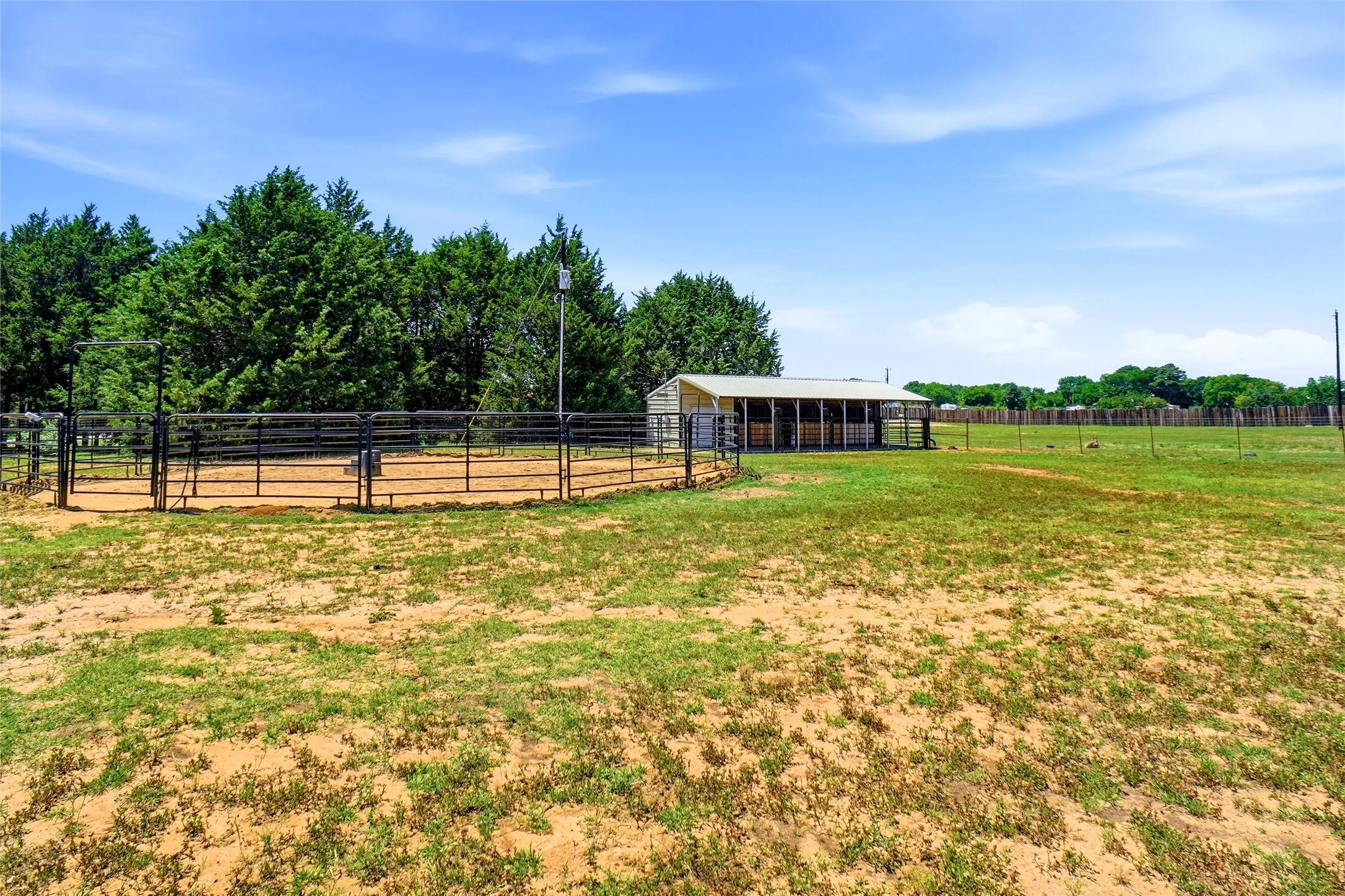 Round pen and three horse stalls